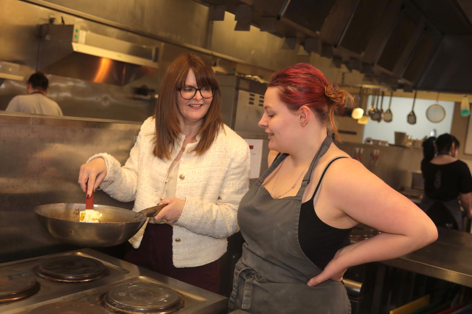 COOKING UP A STORM: Economy Minister Caoimhe Archibald with Kayleigh Price at Springvale Training