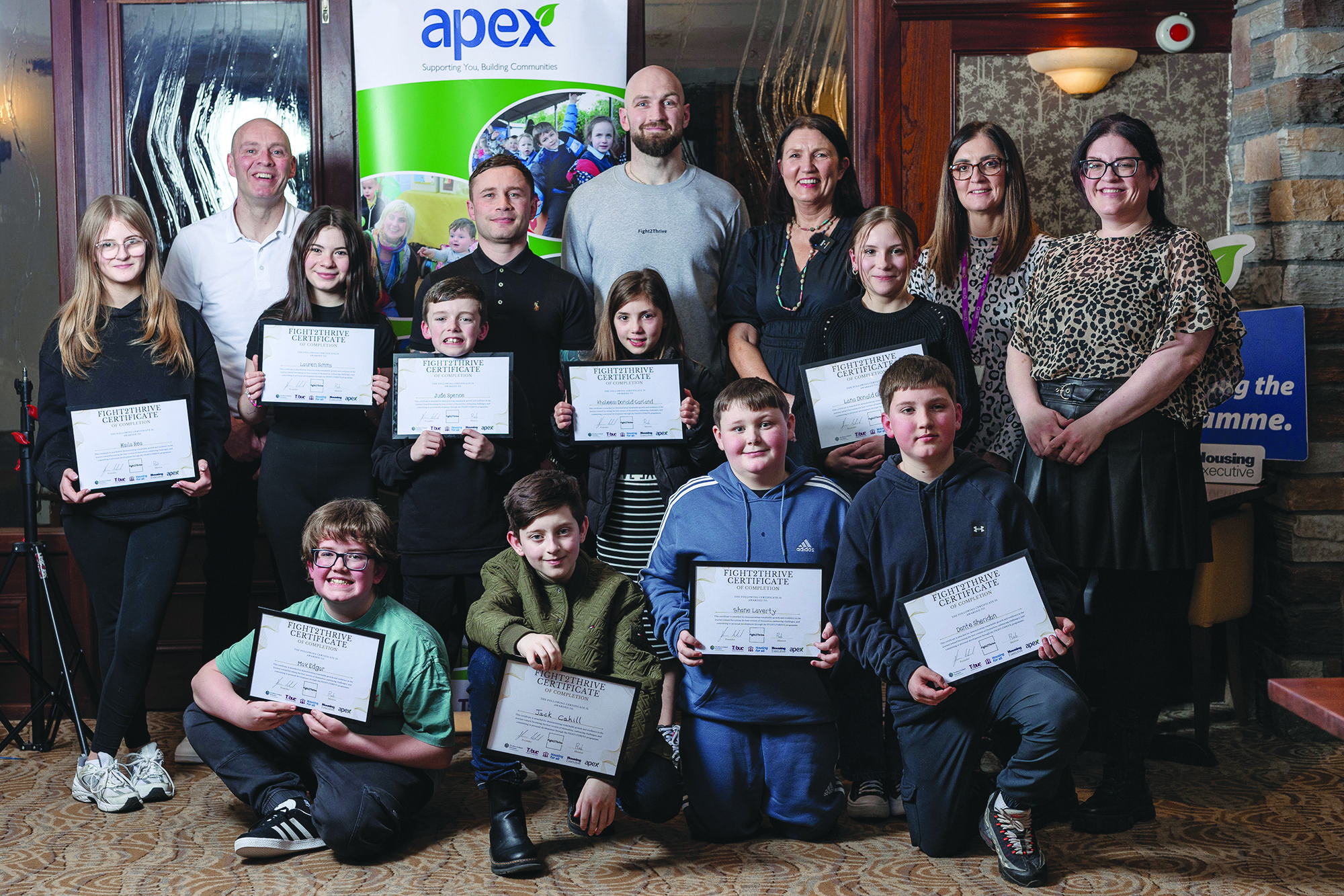 Young people from the Dunmurry group with Steven Ward, Carl Frampton and Teresa McCloskey (Apex Housing Association)