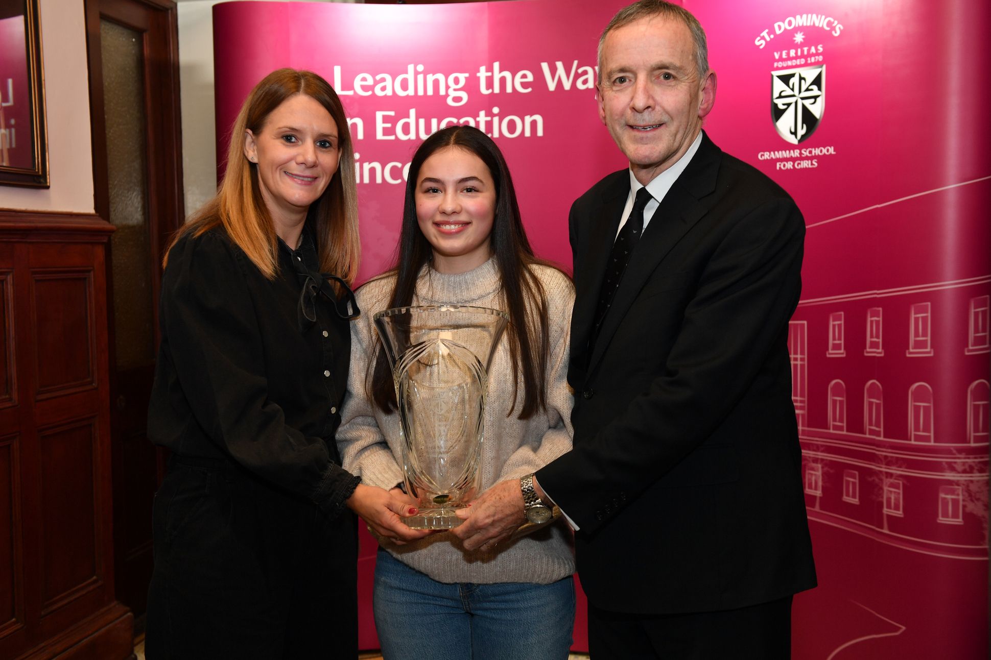 Mrs Cassidy and Mr Moloney present Ciara Maguire with the Moloney Trophy for Sport