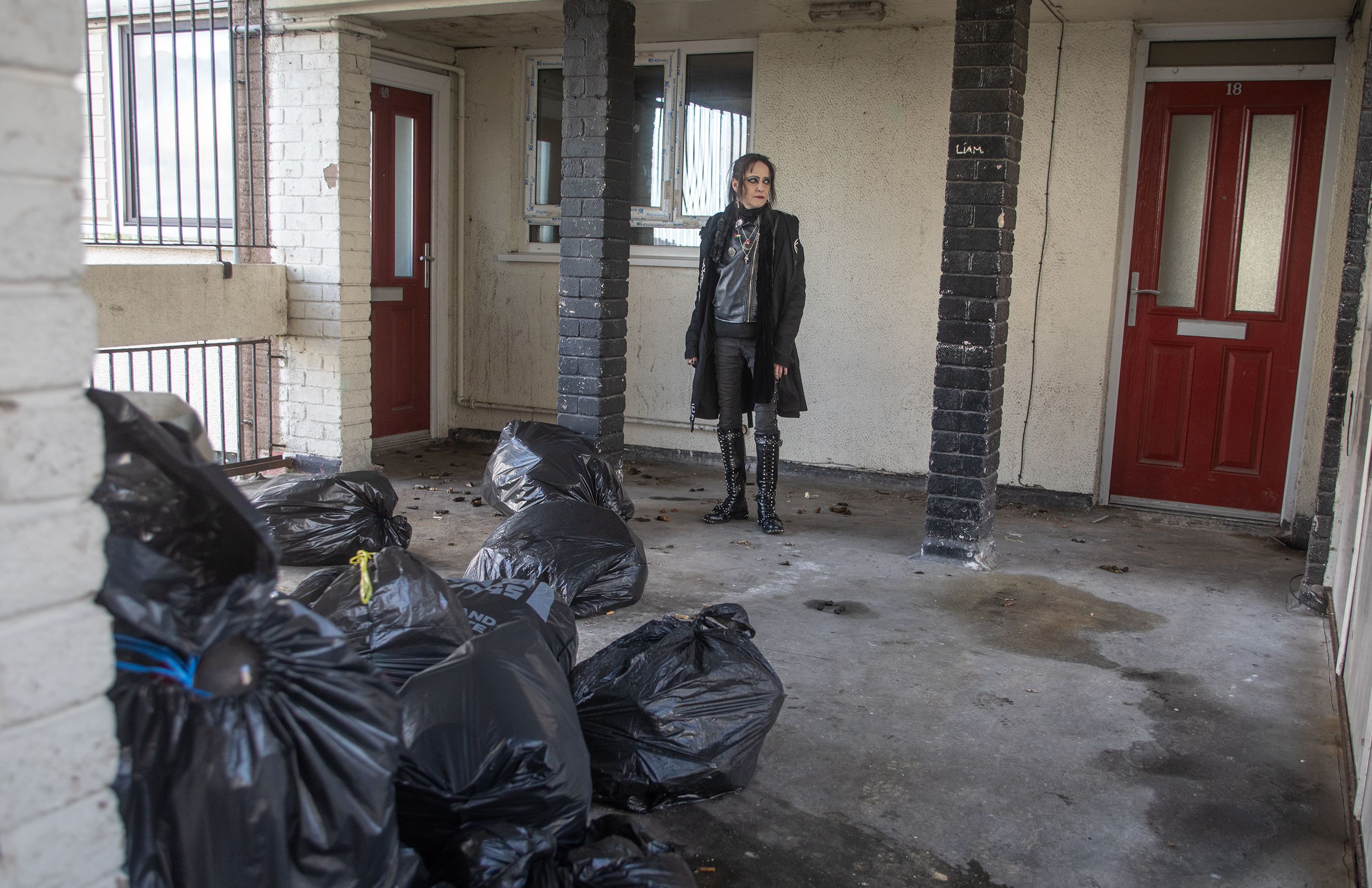 DUMPING: Duncairn Parade resident Cáit Ní Mhuiris looks at the rubbish