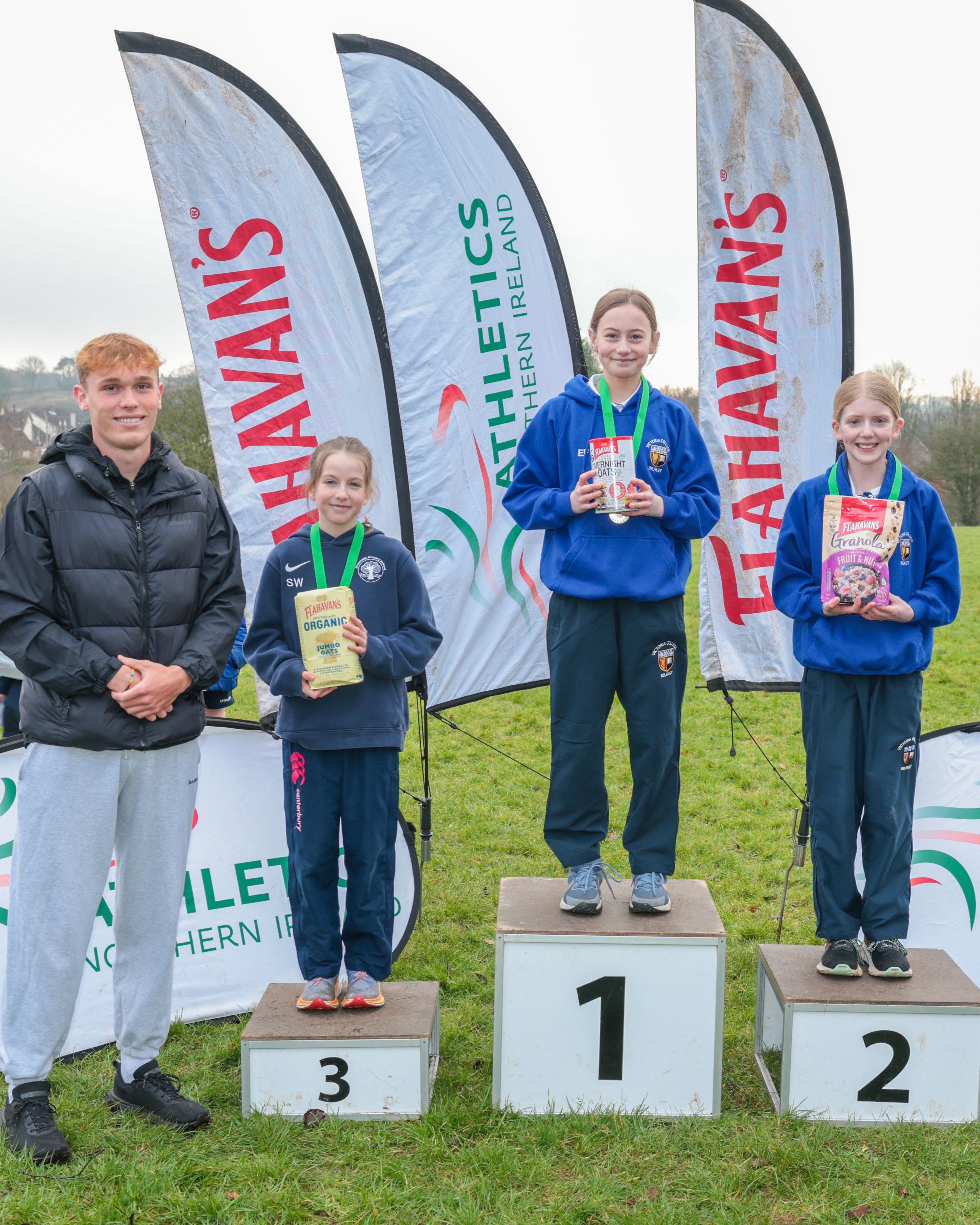Callum Baird, Athletics NI and Flahavan’s League Ambassador; Olivia Johnston from Victoria Prep (second), Esme Falls from Victoria Prep (first), and Emma Wylie from Stranmillis Primary School (third) 