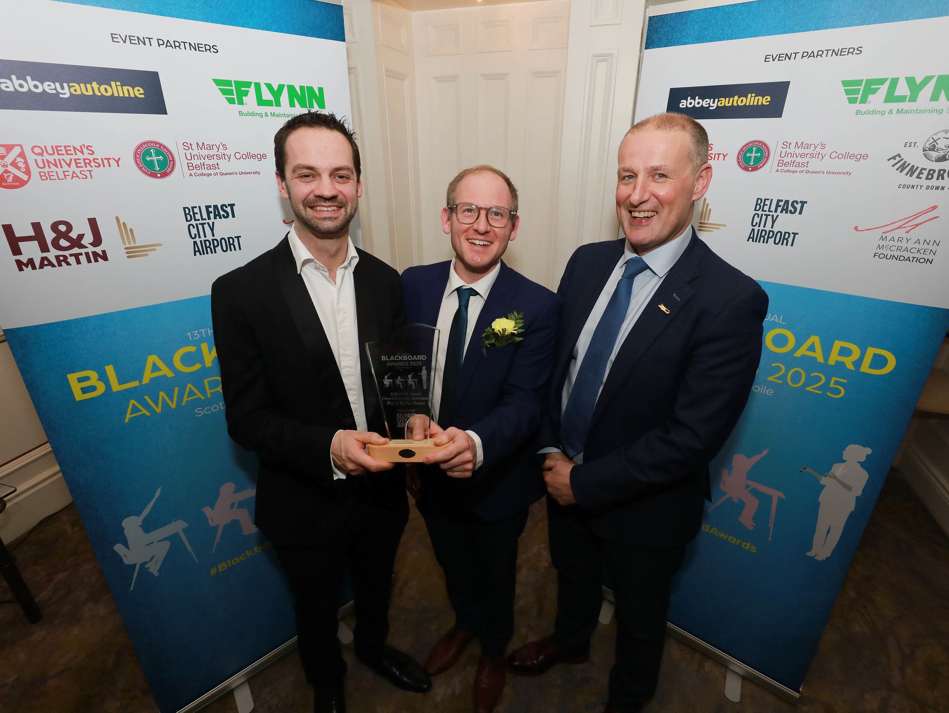 Ross Jonas and Chris Neilands (Play It By Ear Drama) are presented with the 'Cross-Community Ambassador Award' by Mark Beattie (Chief Operating Officer, Belfast City Airport)