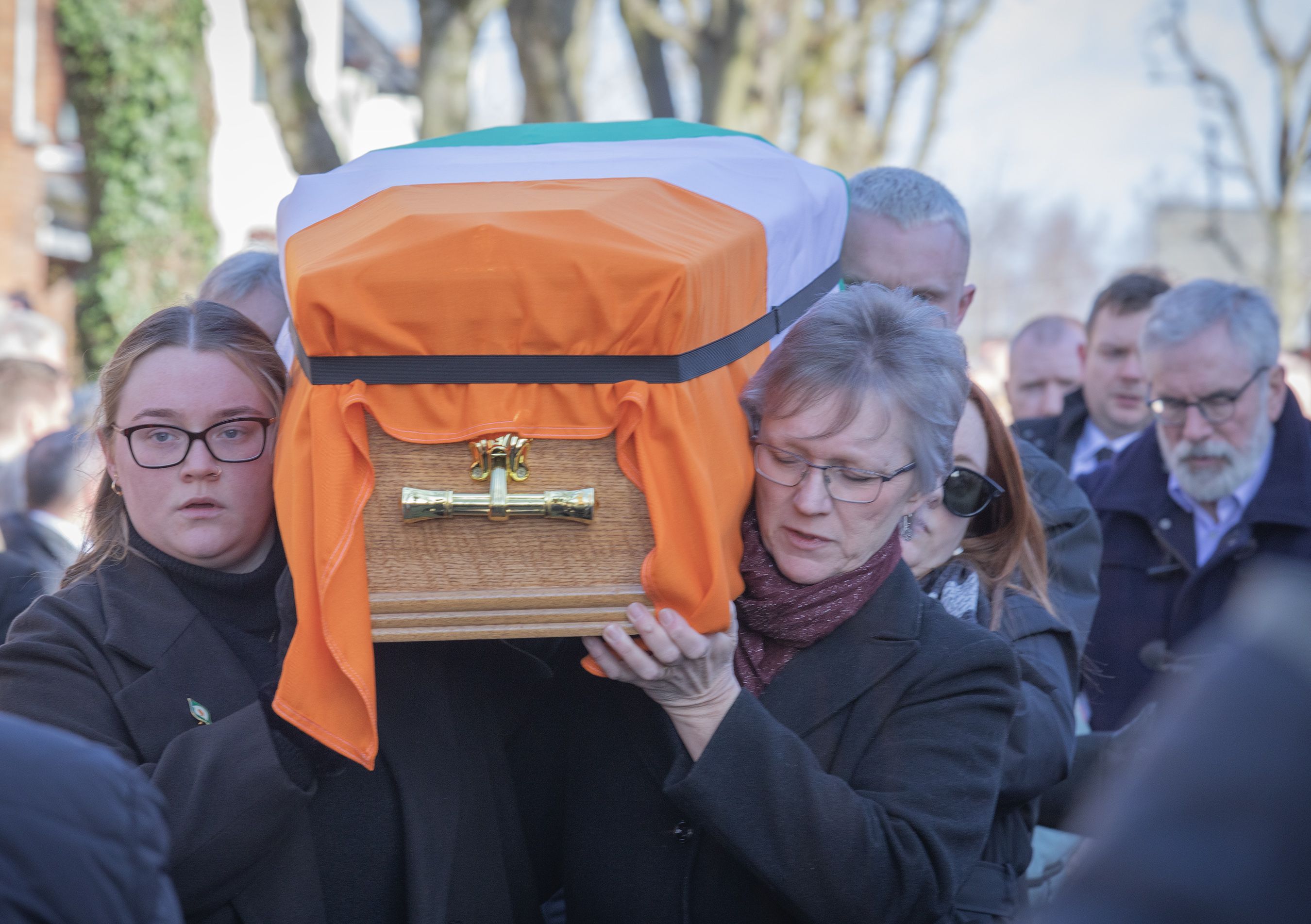 LAST GOODBYE: Bik McFarlane’s wife Lene and daughter Emma carry his coffin