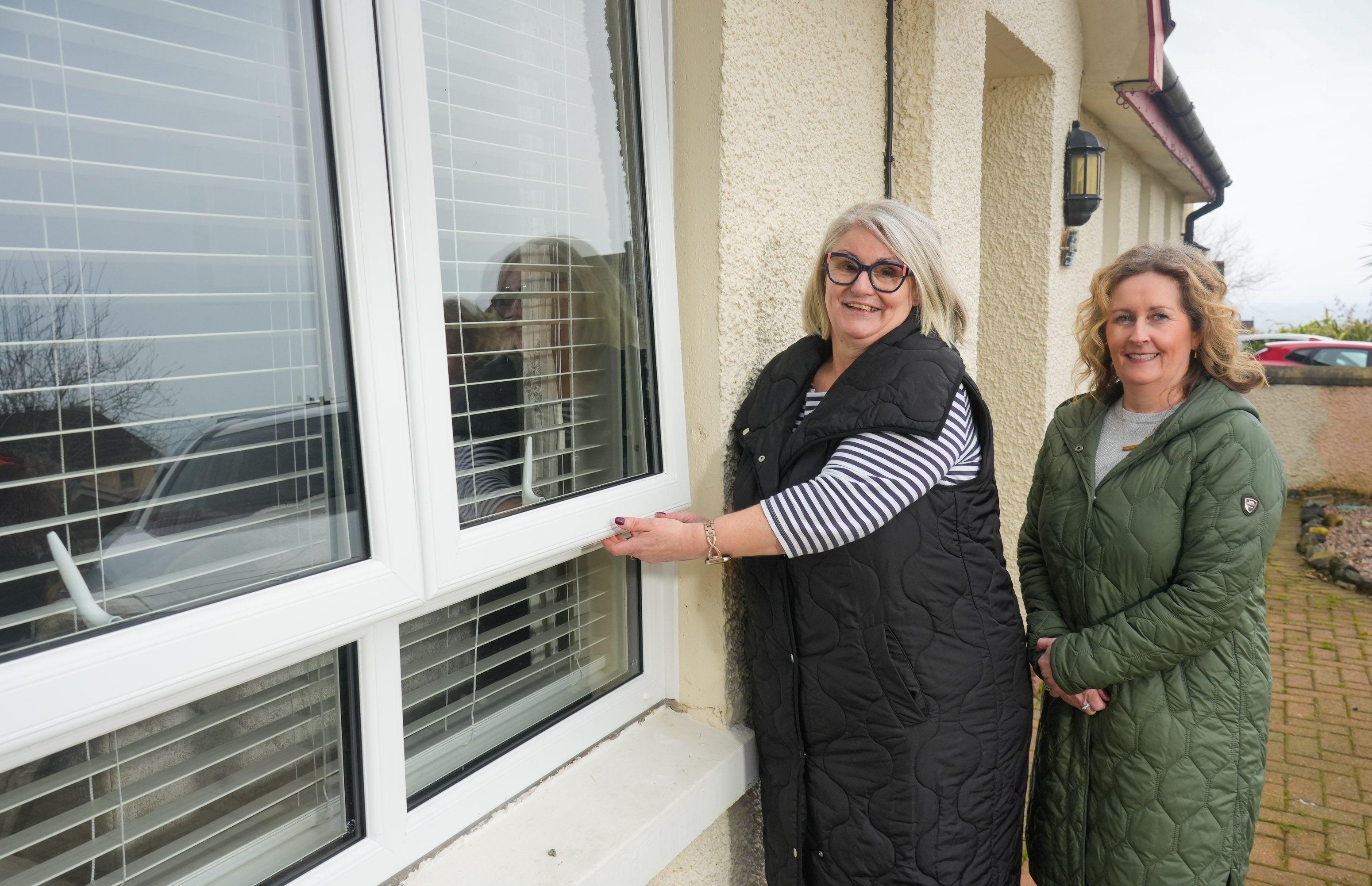 DOUBLE-GLAZED: Lagmore resident Kate McCormick with Housing Executive Patch Manager Alison Devenney