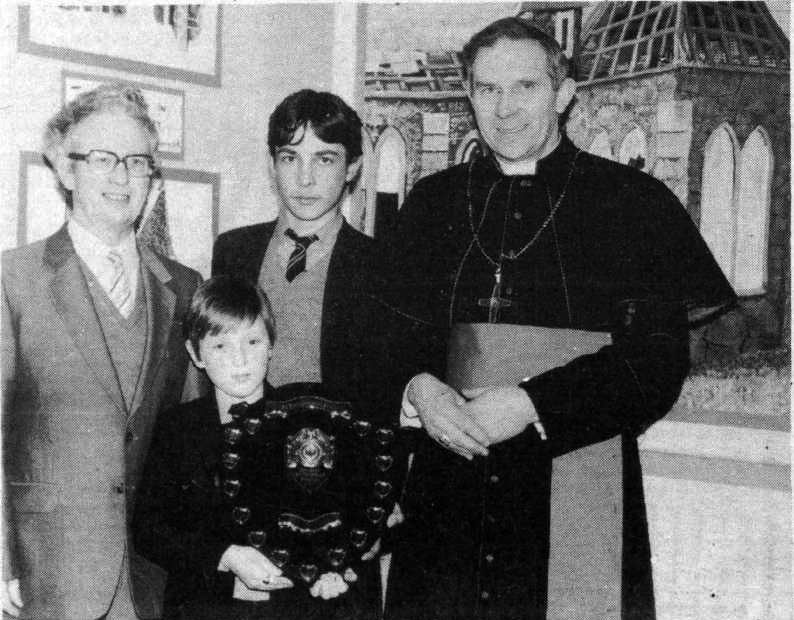 WELL DONE: Principal of St Thomas’ Mr B Carville and Bishop Walsh with Anthony McDonnell and Michael Weir with their award for outstanding community work