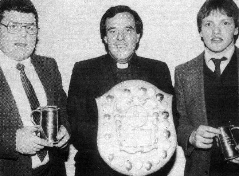 MAITH SIBH: Lámh Dhearg president Fr Matt Wallace made awards to joint clubman of the Year Sean Maguire and Pat McCabe in 1984