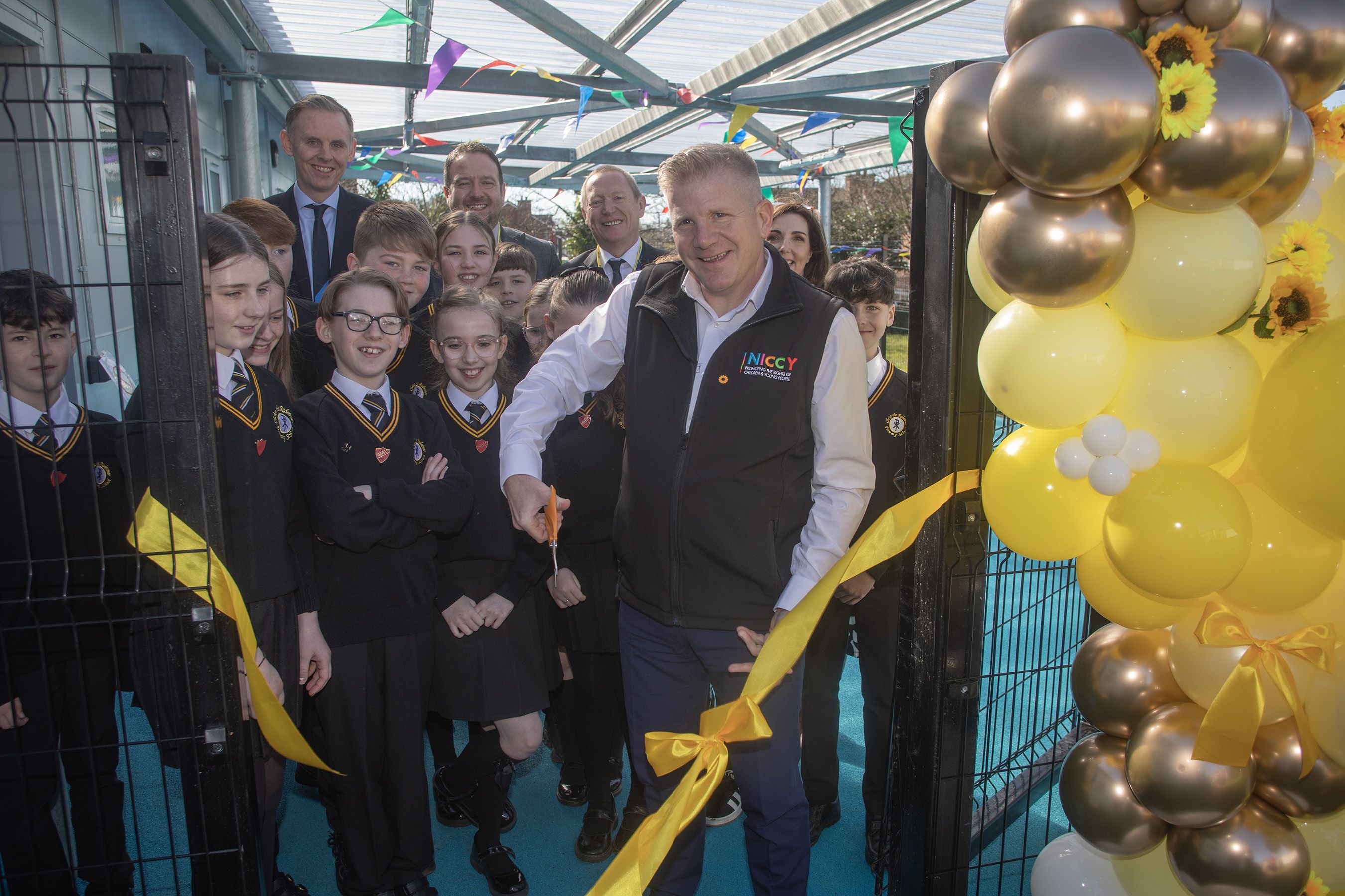 OPENING: Chris Quinn, NI Commissioner for Children and Young People, cuts the ribbon of the new Sunflower Room at Christ the Redeemer PS