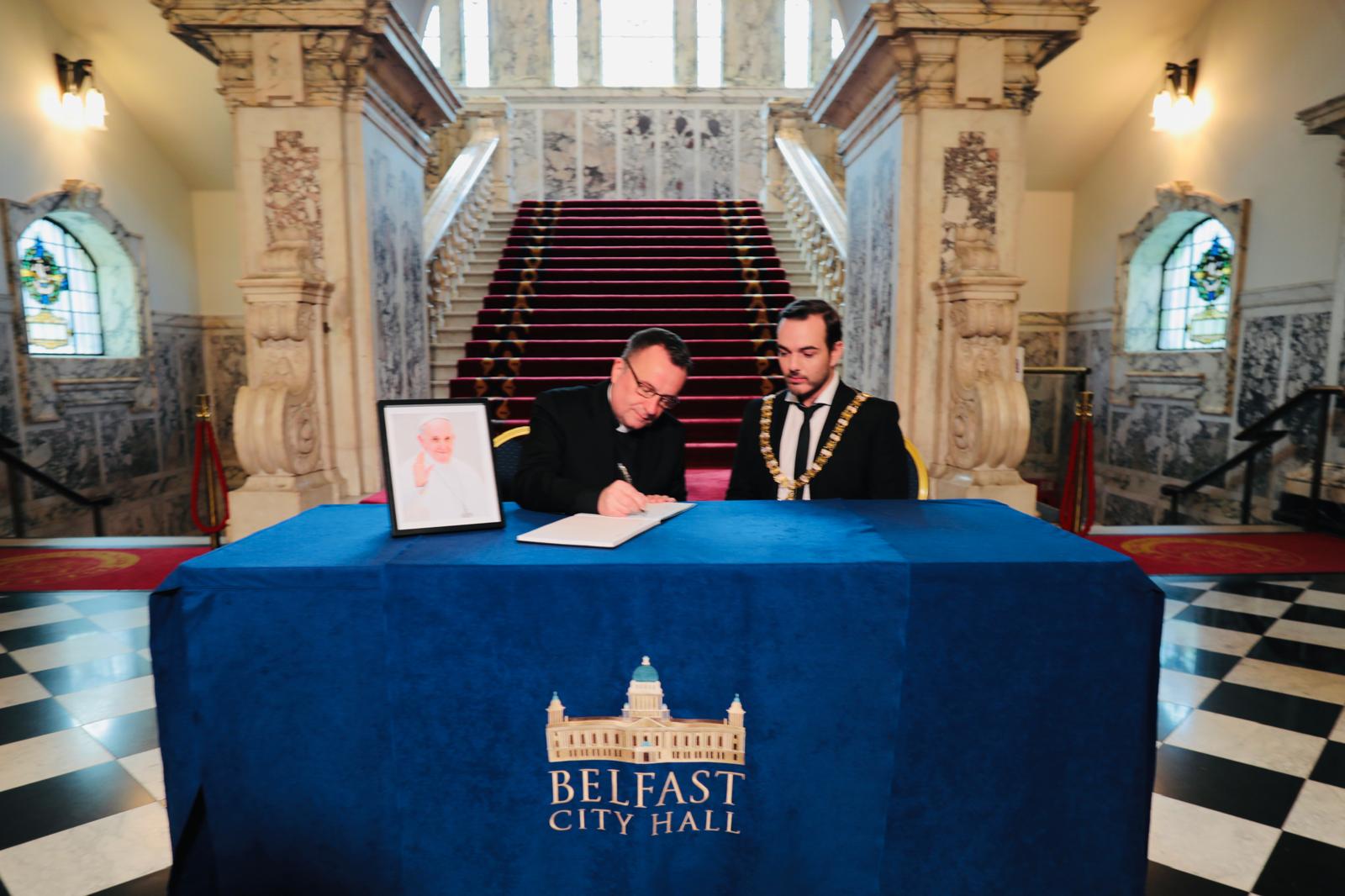 BOOK OF CONDOLENCE: Fr Tim Bartlett and Lord Mayor Councillor Micky Murray at Belfast City Hall on Wednesday