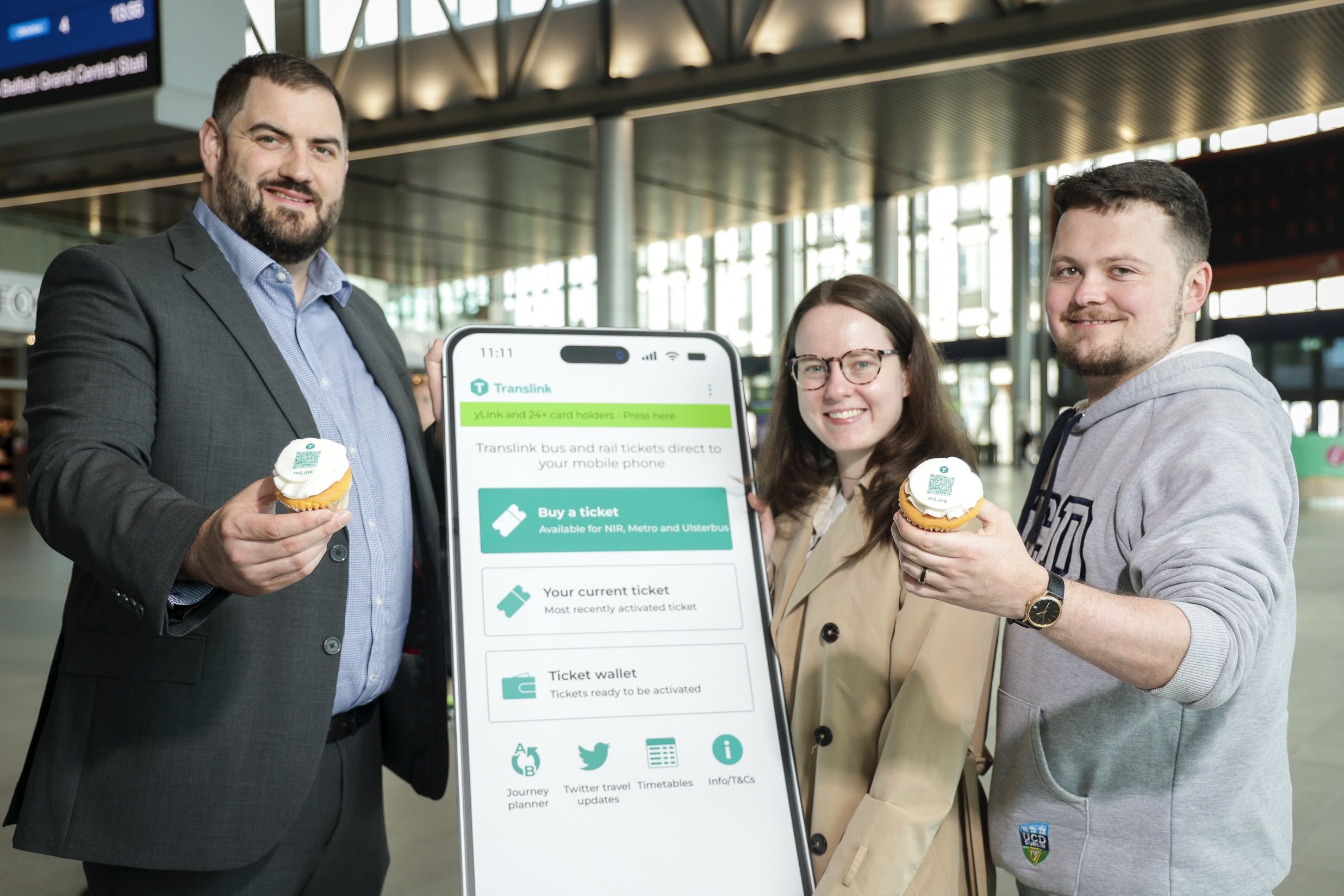MAKING THE MILESTONE: Translink\'s Mark Davidson with passengers, Emily and Brian Moore