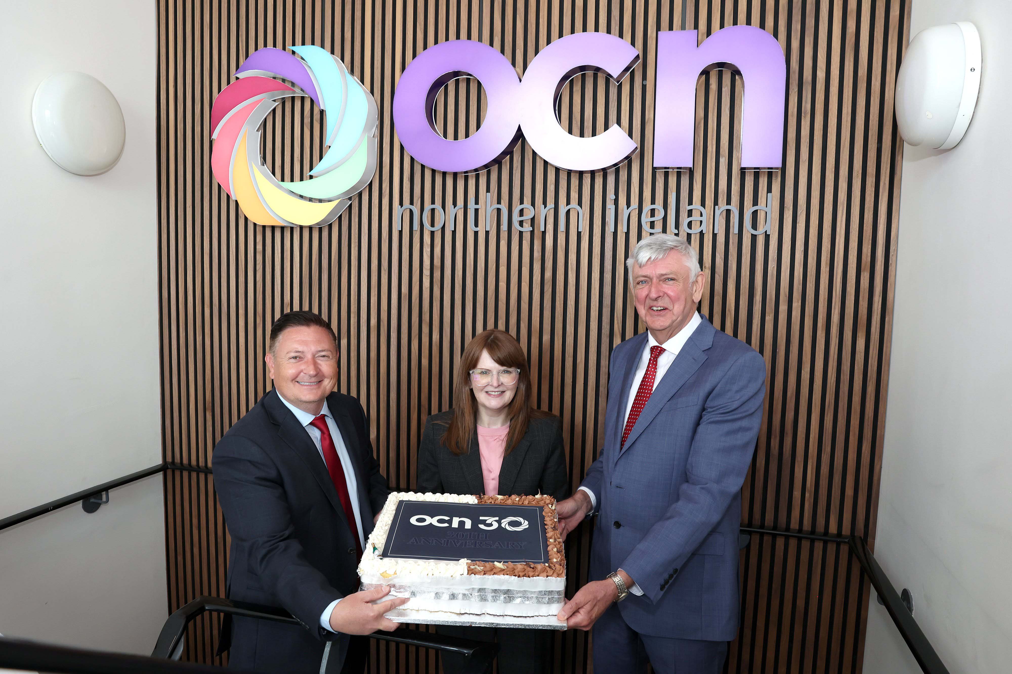 30 YEARS: OCN Chief Executive Martin Flynn (left) and OCN Chairperson Paul Donaghy welcomed Economy Minister Dr Caoimhe Archibald MLA to their Belfast headquarters