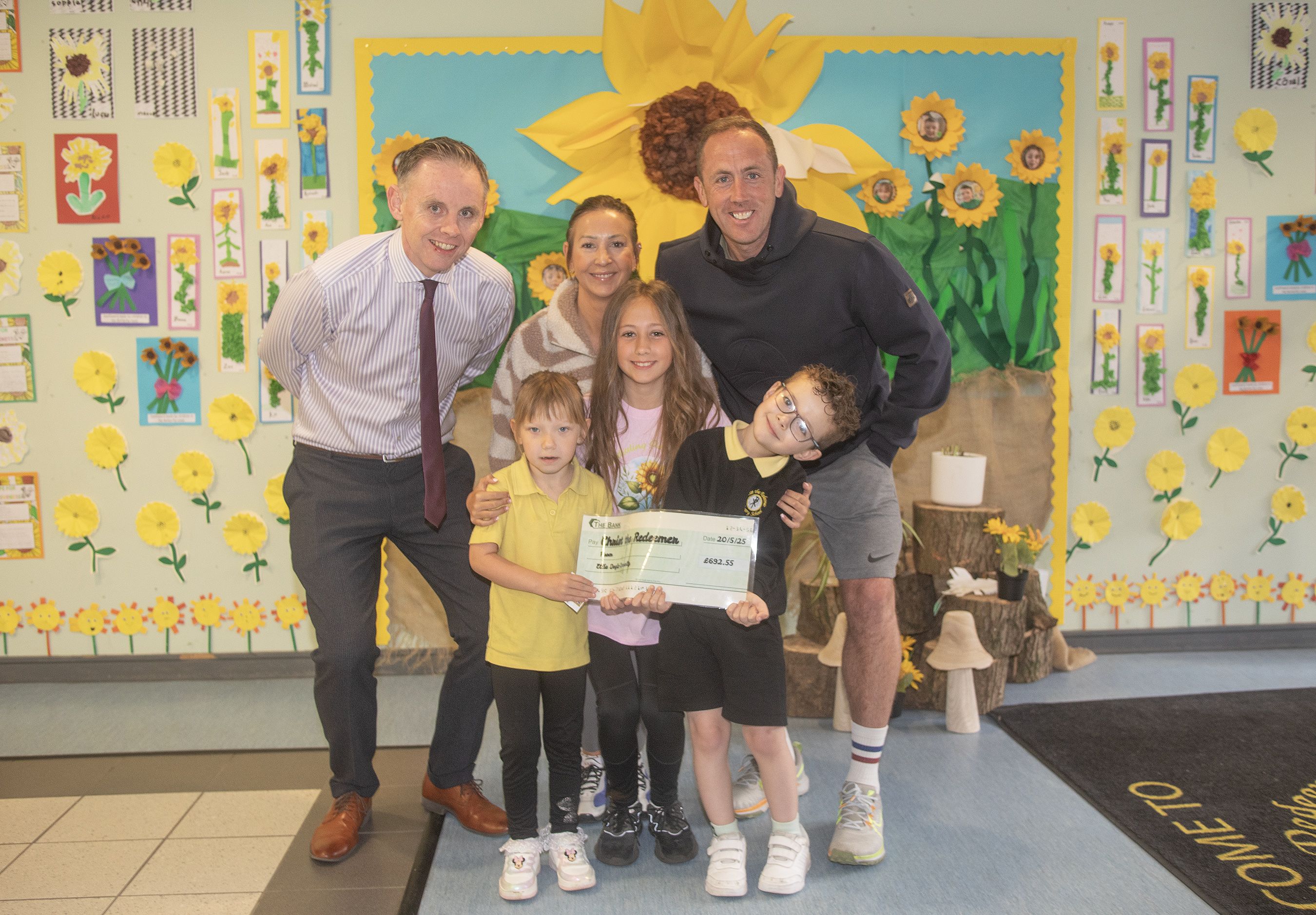Ellie Doyle Connolly with mum and dad Emma and Michael and Killian and Keva Leigh and Principal Neil Watson