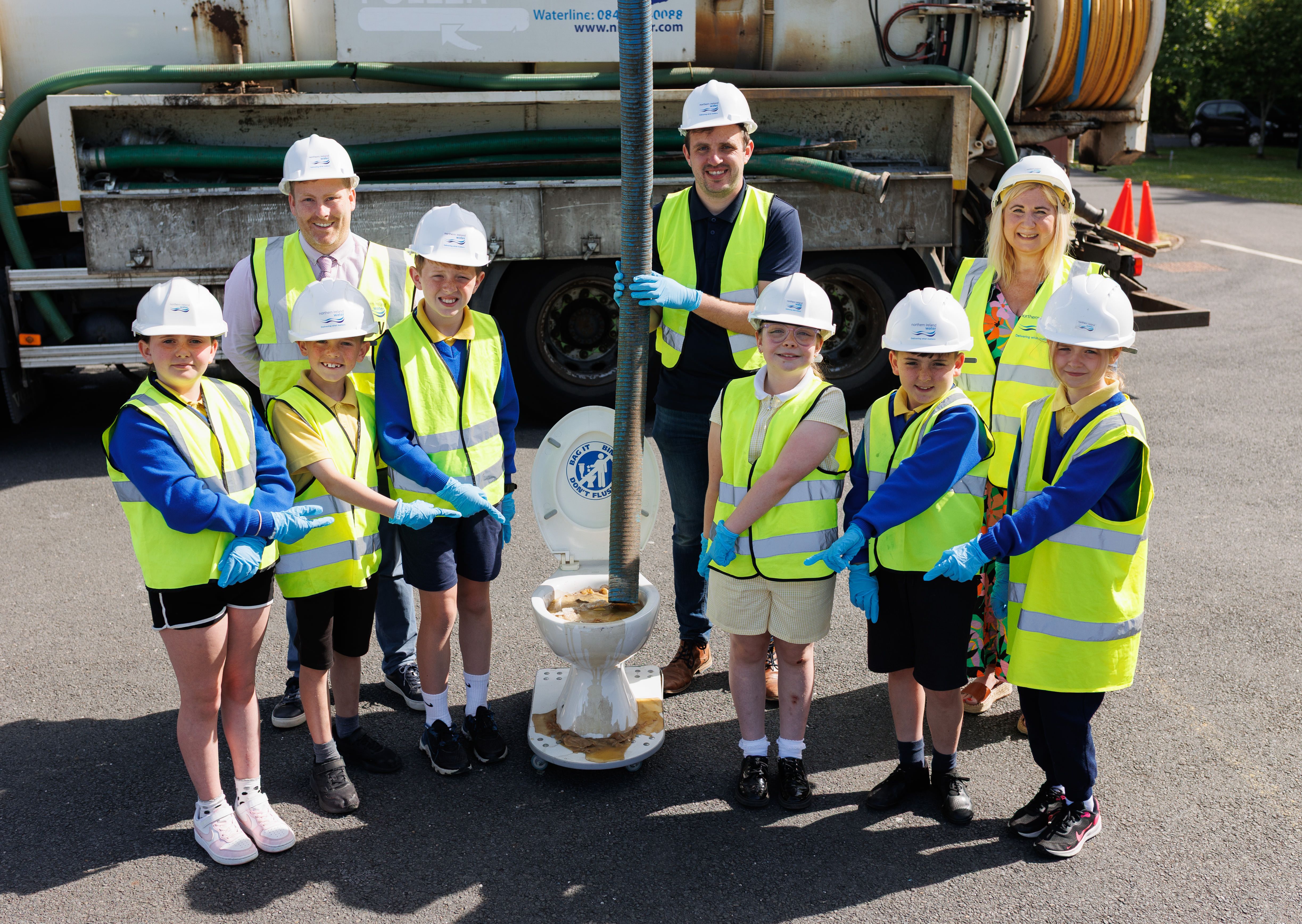 THREE PS: Pupils from Our Lady Queen of Peace Primary School Dunmurry with NI Water Customer Field Manager Daniel Toal and Sinn Féin Councillor Siobhán McCallin