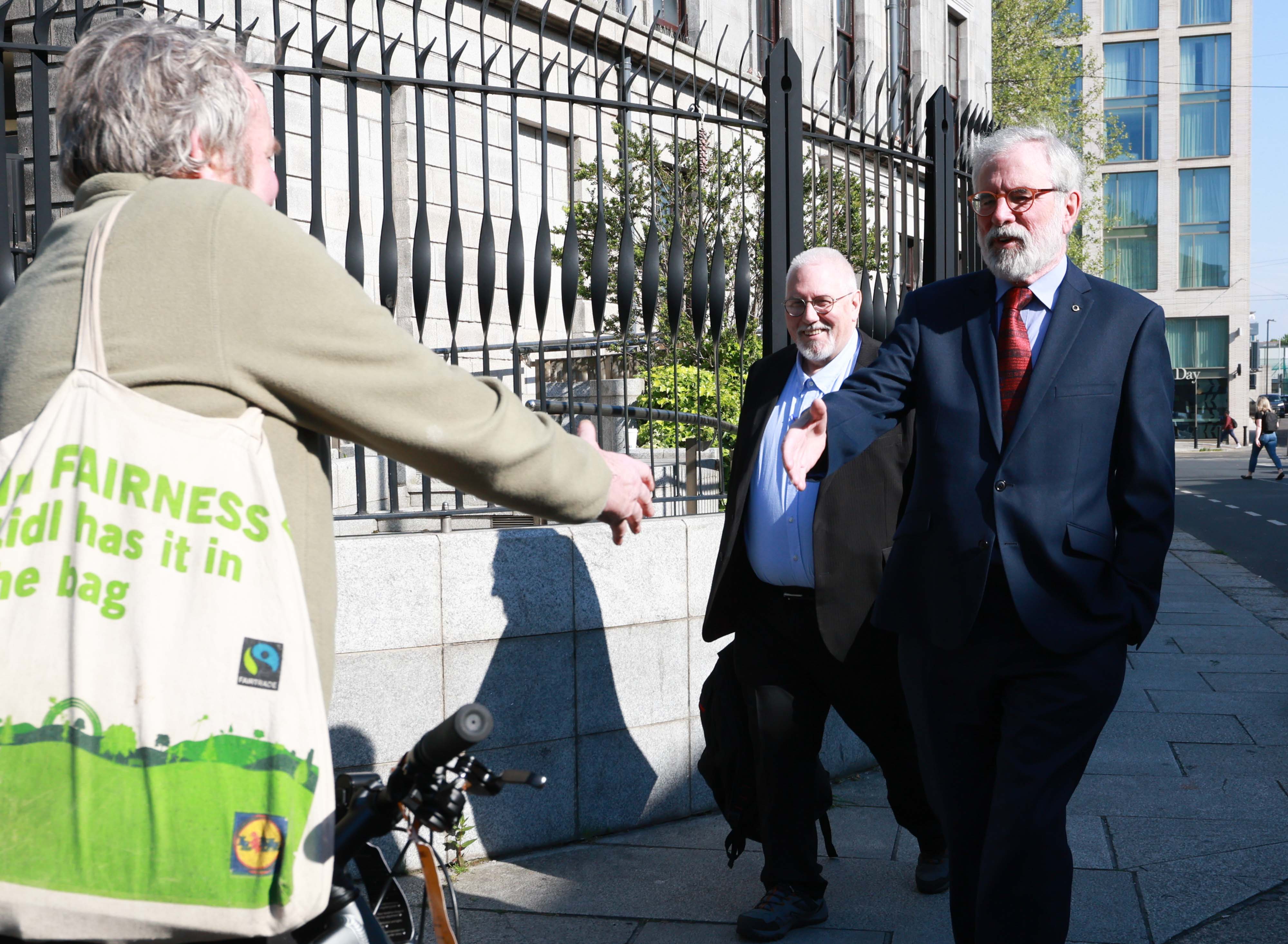 MARATHON: A jubilant Gerry Adams is greeted by a well-wisher at the end of the five-week libel trial