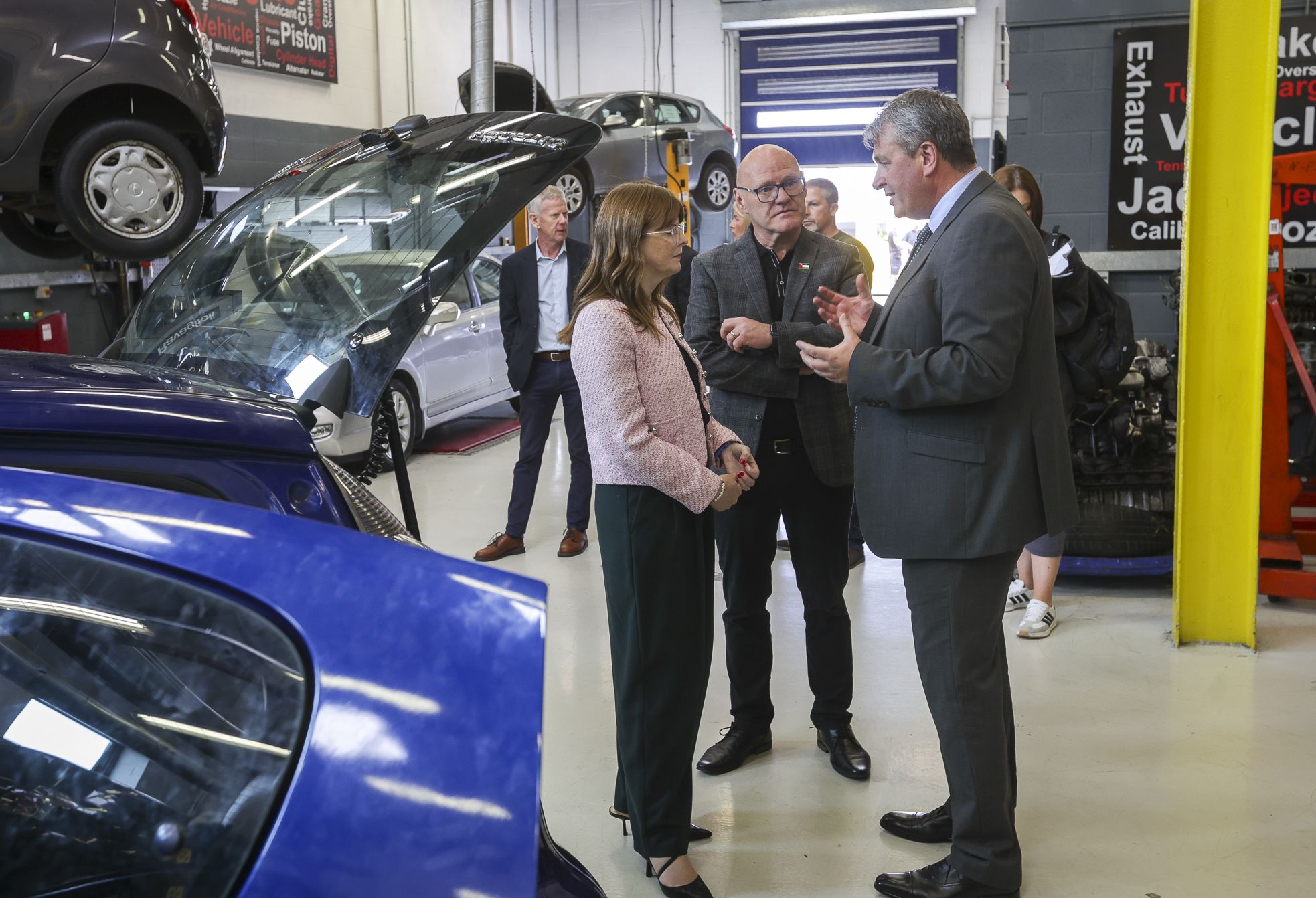 VISIT: Economy Minister Caoimhe Archibald with Paul Maskey MP and Paul Boyle at Workforce