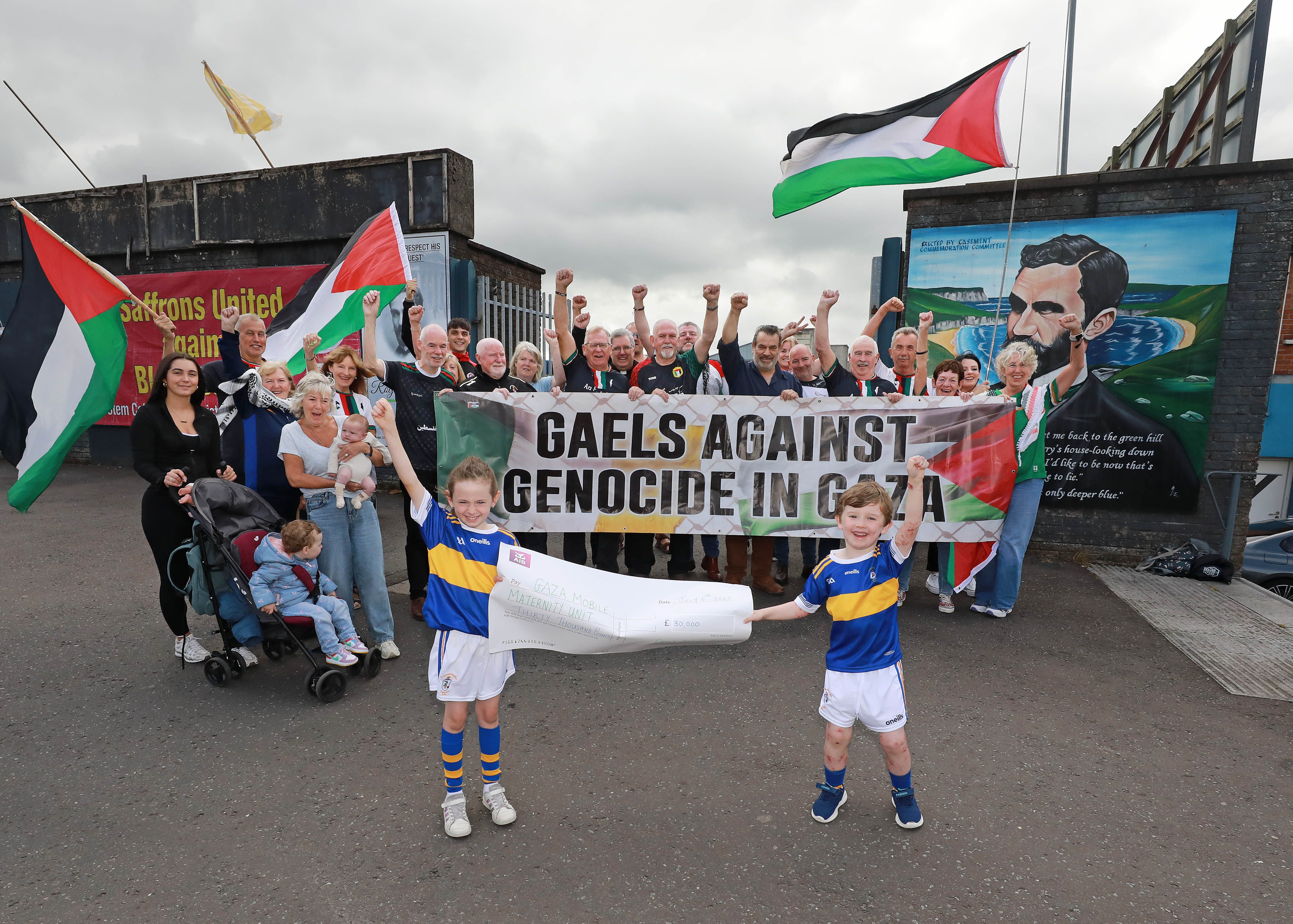 FUNDRAISING: Gaels Against Genocide in Gaza outside Casement Park for a cheque presentation of £30.000 raised for a mobile maternity unit in Gaza.