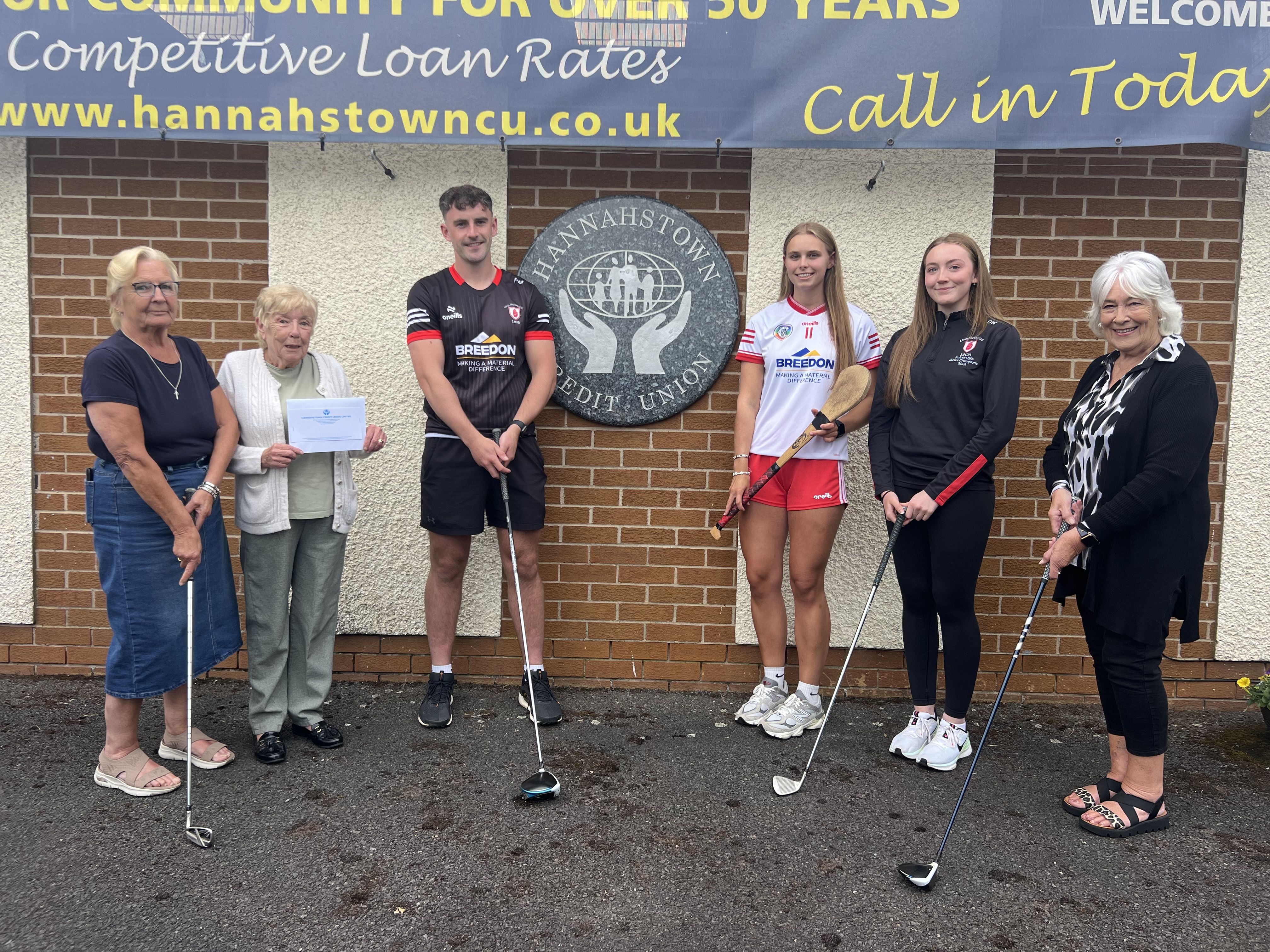 Members of Hannahstown Credit Union Board Lorraine Hanna, Director; Mary Nesbitt, Interim Chairperson; and Joan Carville, Supervisor; present a cheque to Lámh Dhearg senior players Pádraig Mervyn, Dervla McAufield and Orlaith Webb