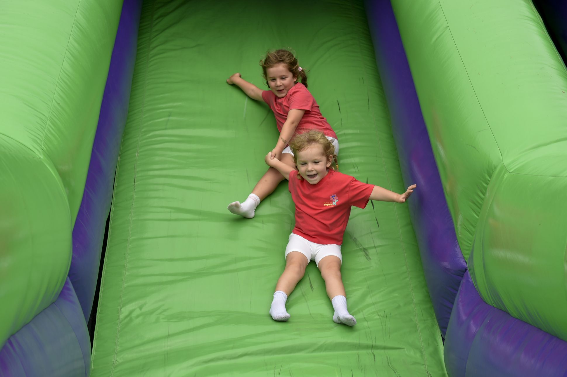 Mila and Sfia enjoying the bouncy castle slide