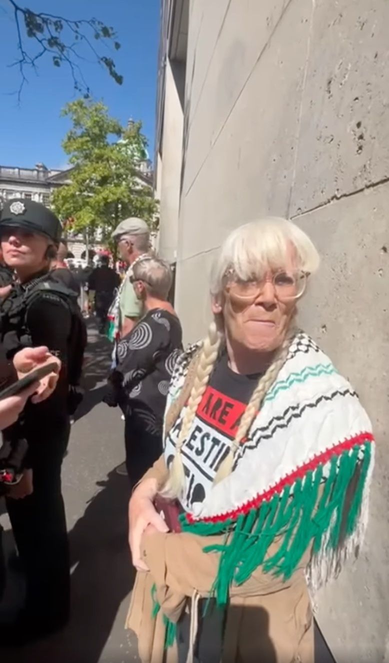 SUPPORT: Marie McNally (74) being held by police before her arrest on Saturday