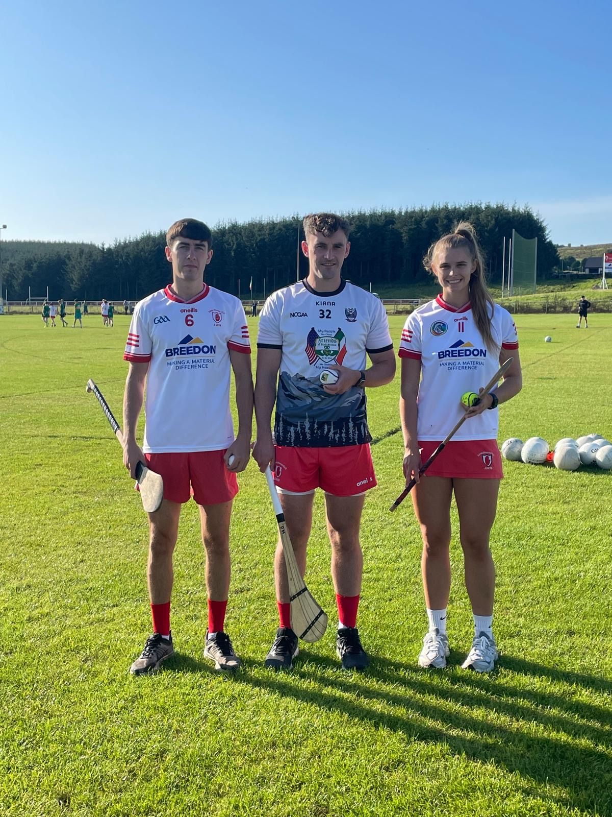 ACROSS THE OCEAN: Senior hurlers Niall McGarry and Paddy Mervyn sporting the Griz jersey, along with senior camog Dervla McAufield with the prized Meagher slíotar which ws kindly donated by Thomas Meagher Hurling Club, Montana