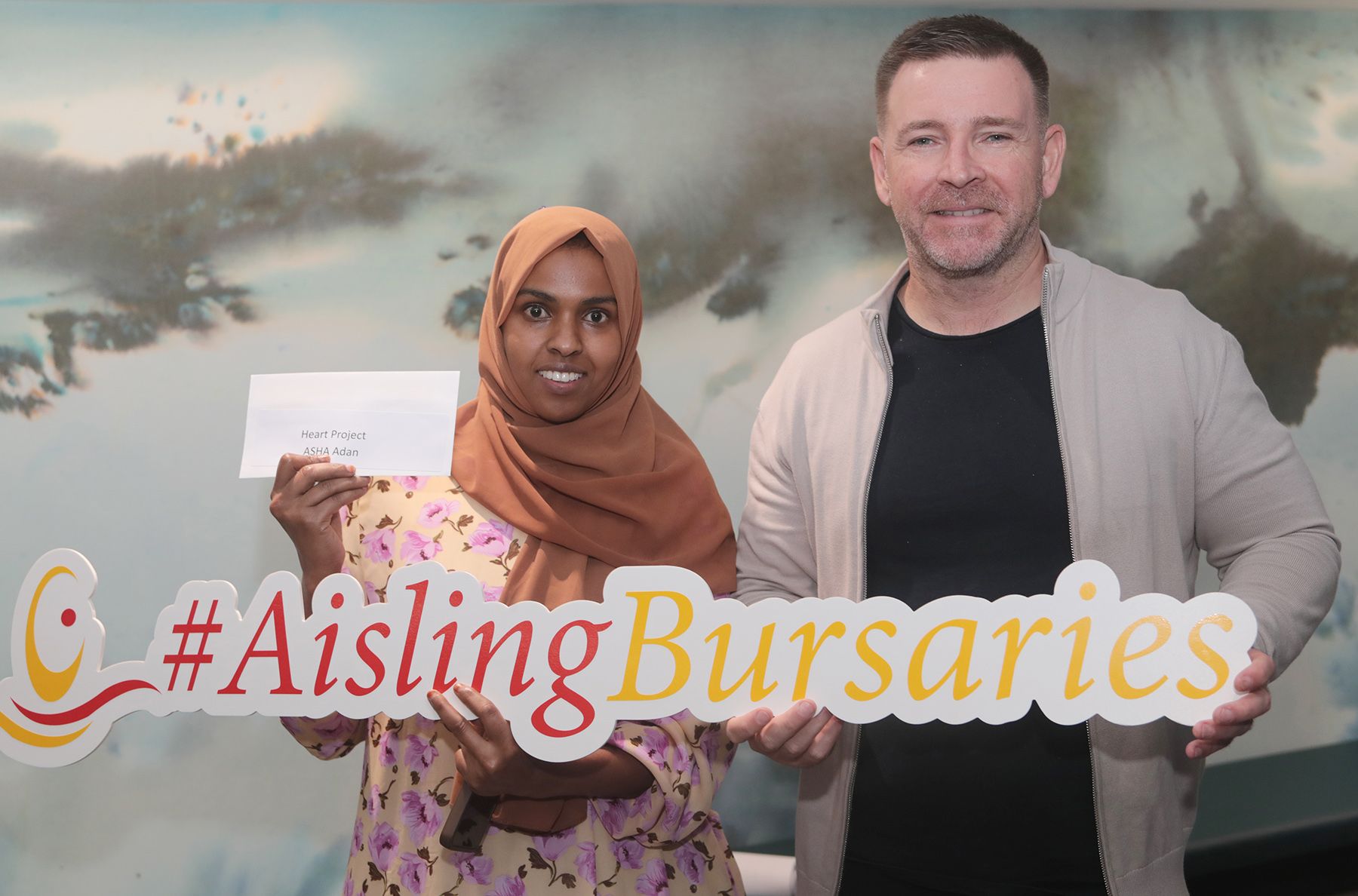 AISLING EDUCATION BURSARIES: Recipient Asha Adan with Terry Quinn from West Belfast Partnership Board