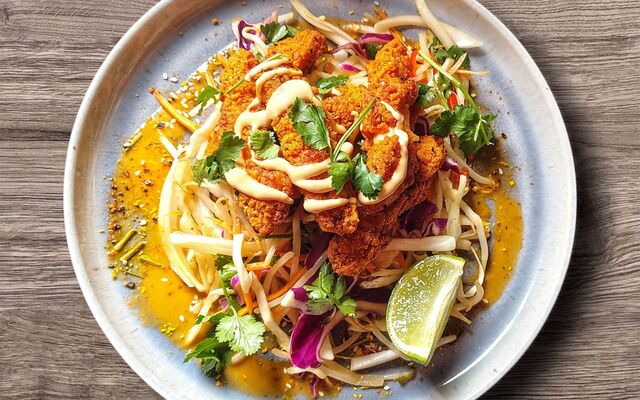 PLATING UP: Blackened Cajun chicken strips on Asian Slaw with curry sauce