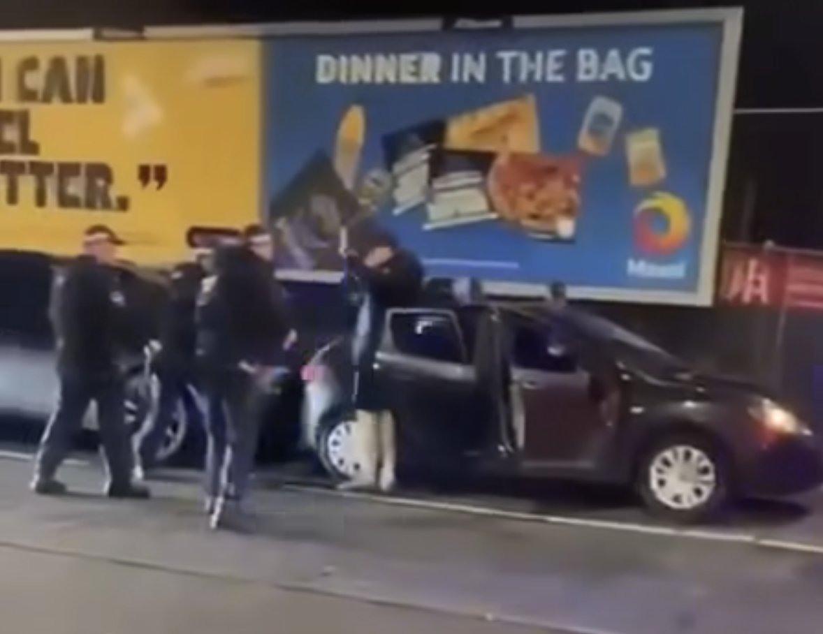 USE OF FORCE: One of the youths has his hands in the air before being dragged to the ground