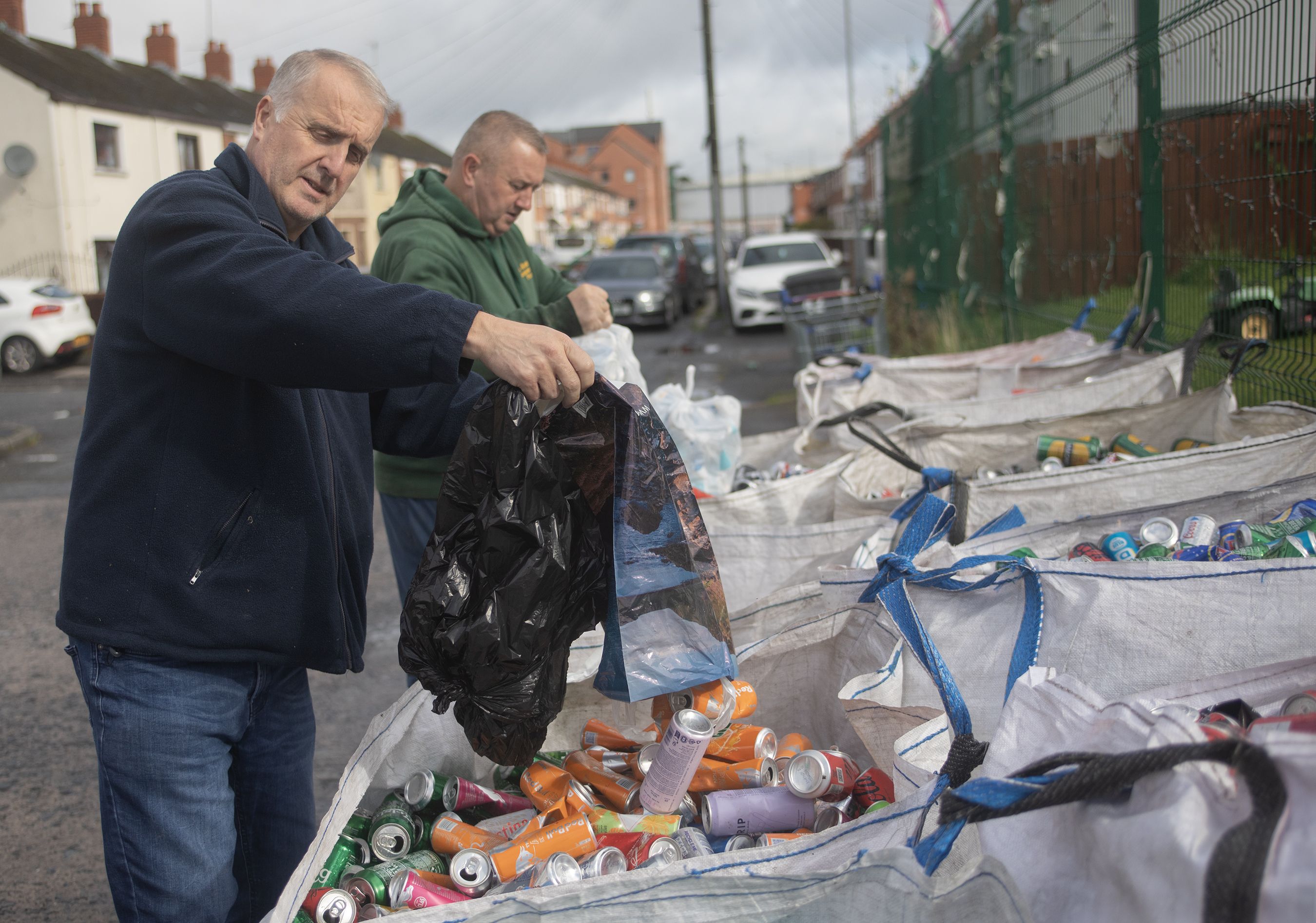 YOU CAN DO IT: Thomas McIlhone and Damien Lindsay empty the latest donation of cans