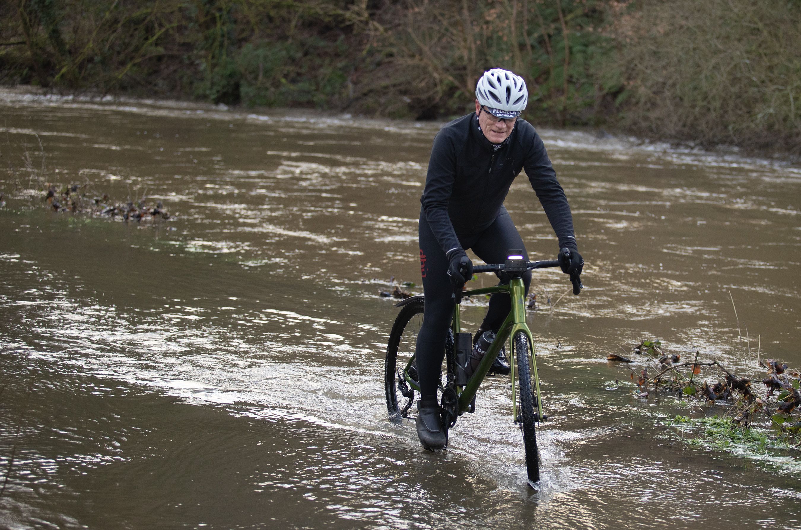 MORE RAIN COMING: A cyclist battles through water along the towpath on Thursday morning next to the River Lagan