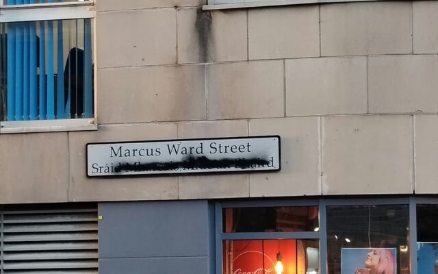 Bilingual street sign defaced in city centre
