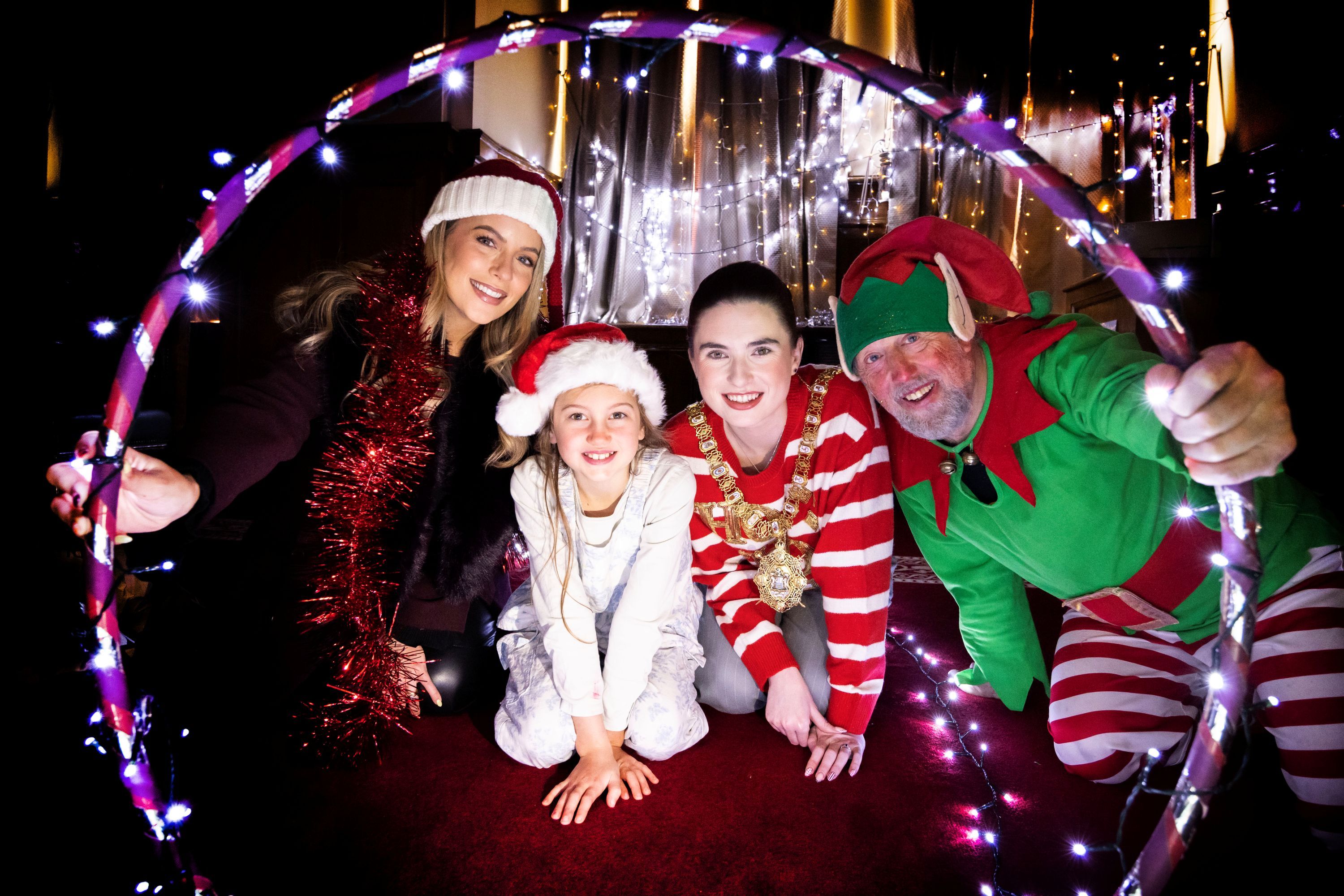 CHRISTMAS LIGHTS SWITCH-ON: Lord Mayor of Belfast, Councillor Róis-Máire Donnelly and Melissa Riddell from Cool FM with Santa’s elf Bucky and youngster Niyah