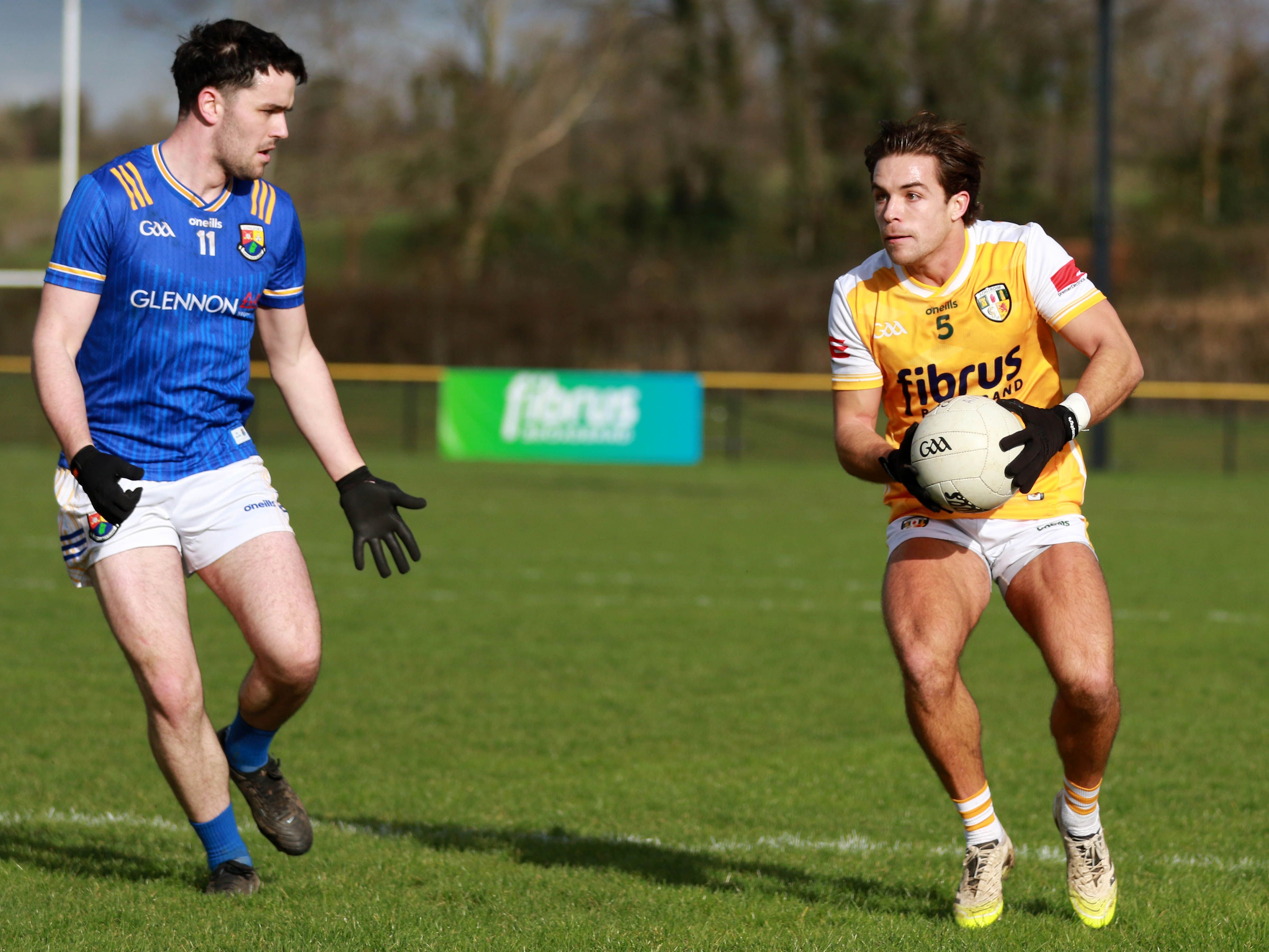 Captain Eoghan McCabe retains possession for Antrim