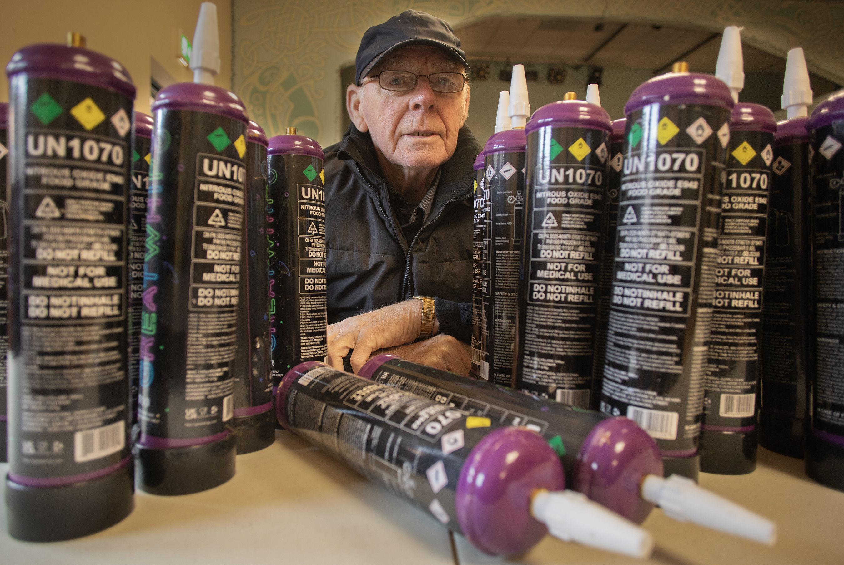 CONCERN: Frank Dempsey from Carrick Hill Residents\' Association with the canisters discovered in the district at the weekend