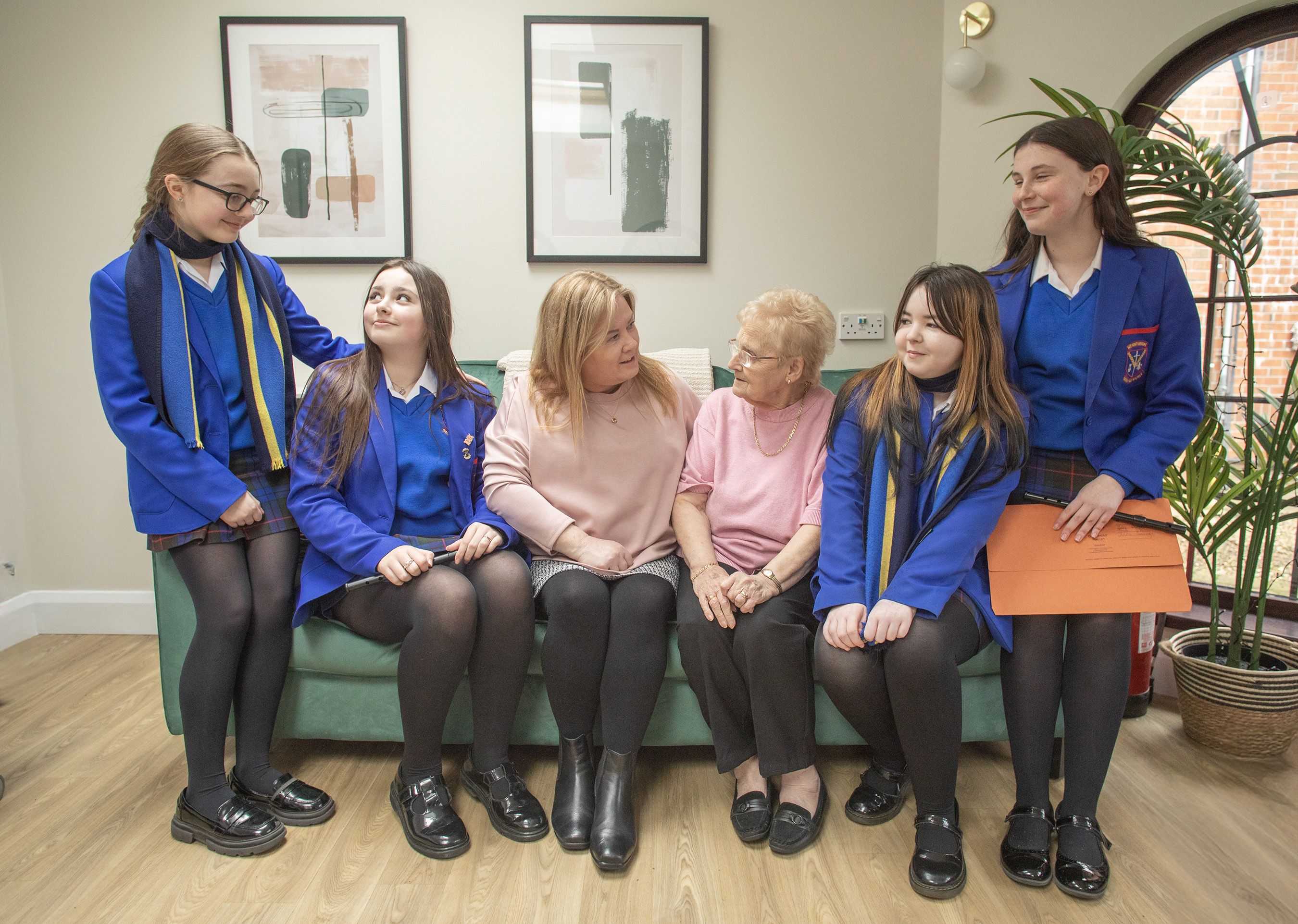CATCHING UP: Marie McConnell (scheme supervisor), Angela Jordan (tenant) with Éabha O’Brien, Ellie Agathangelou, Caoimhe Connolly and Holly Doherty from St Genevieve\'s 