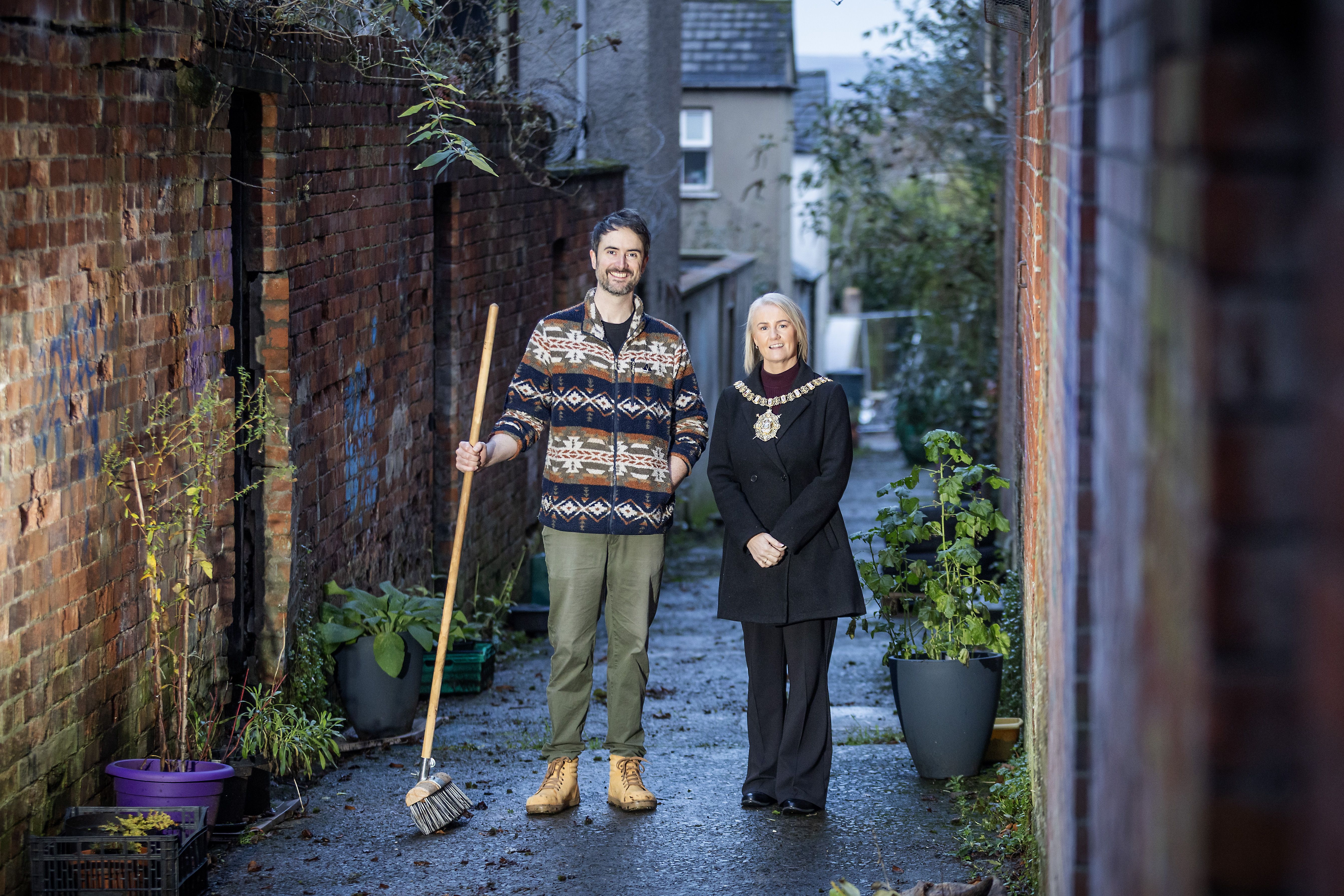 CLEAN SWEEP: Lord Mayor of Belfast, Councillor Tracy Kelly, with Shane McLaughlin who has been working with his wife, Olivia McIntyre, to regenerate an alley in the Stranmillis area which has been named Foxglove Alley