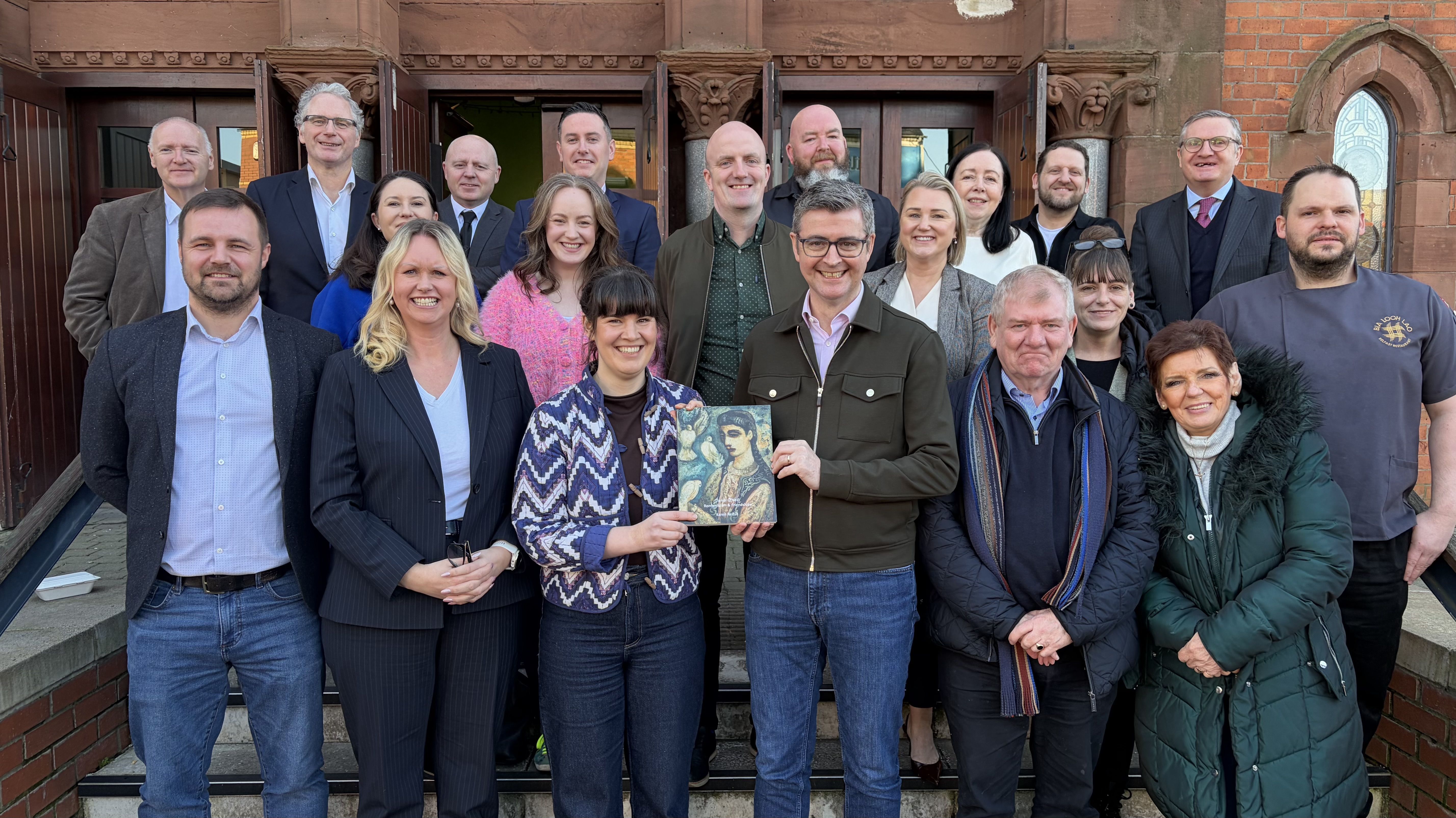 FULL HOUSE: Brendan Money was presented with a biography of West Belfast artist Dan O\'Neill after addressing the West Belfast Small Biz Roundtable