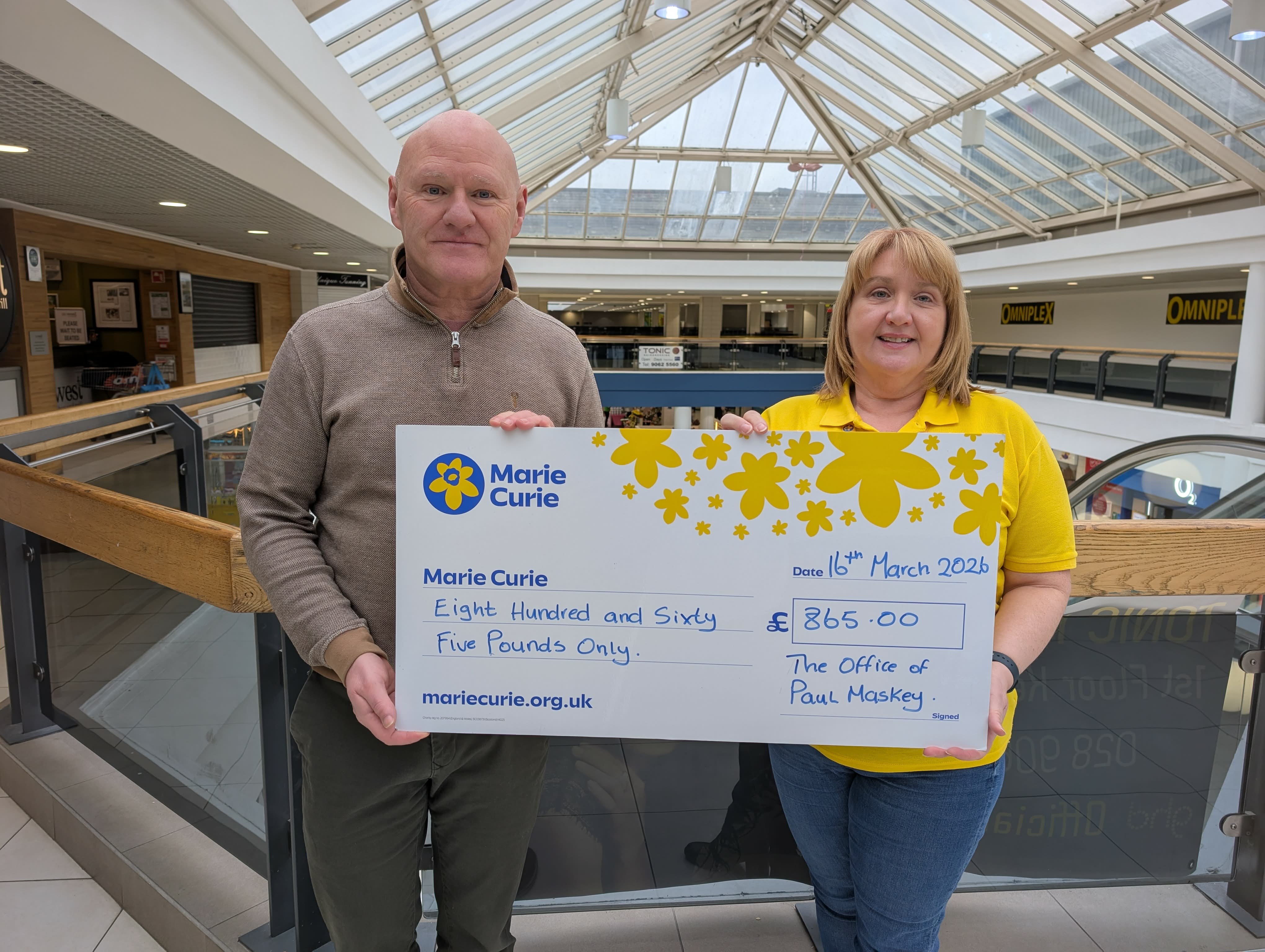 SUPPORT: Paul Maskey hands over a cheque to Marie Harris from Marie Curie