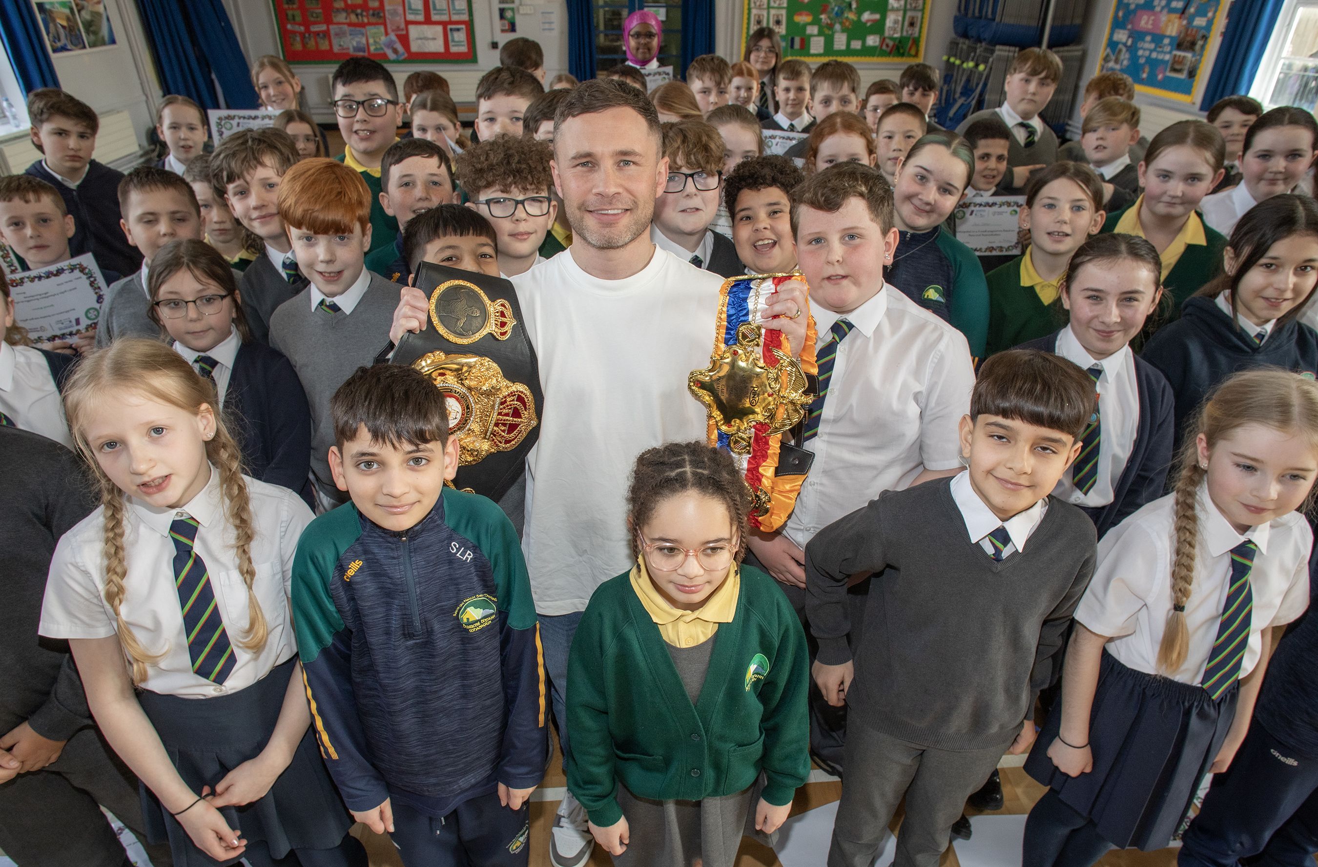 PRAISE: Carl Frampton with pupils from Cliftonville IPS and Bunscoil Bheann Mhadagain