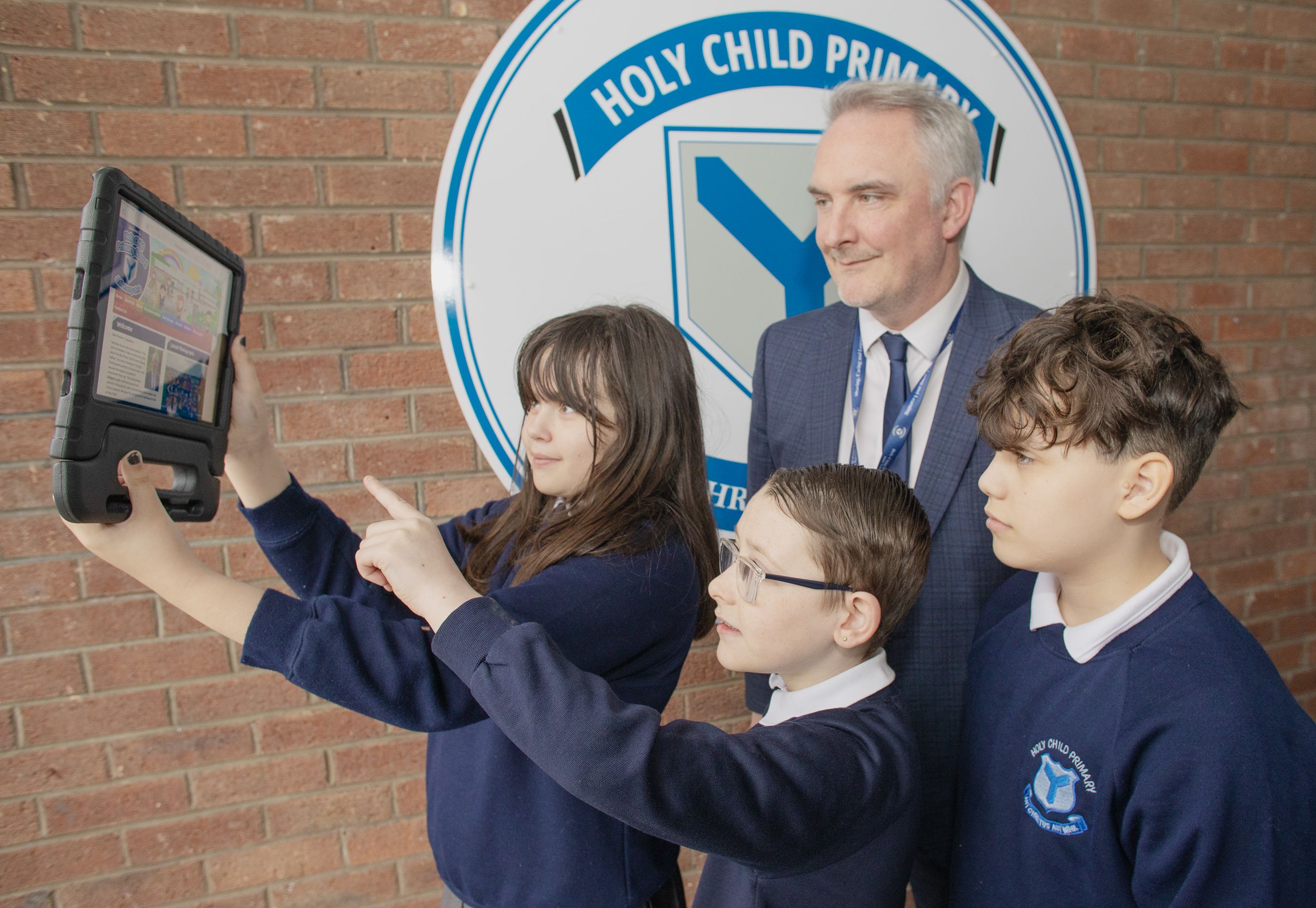 NEW WEBSITE: Holy Child PS Principal Conor Murphy with P7 pupils Lorraine Healy, Stephen Maguire and Kai Bamgbose