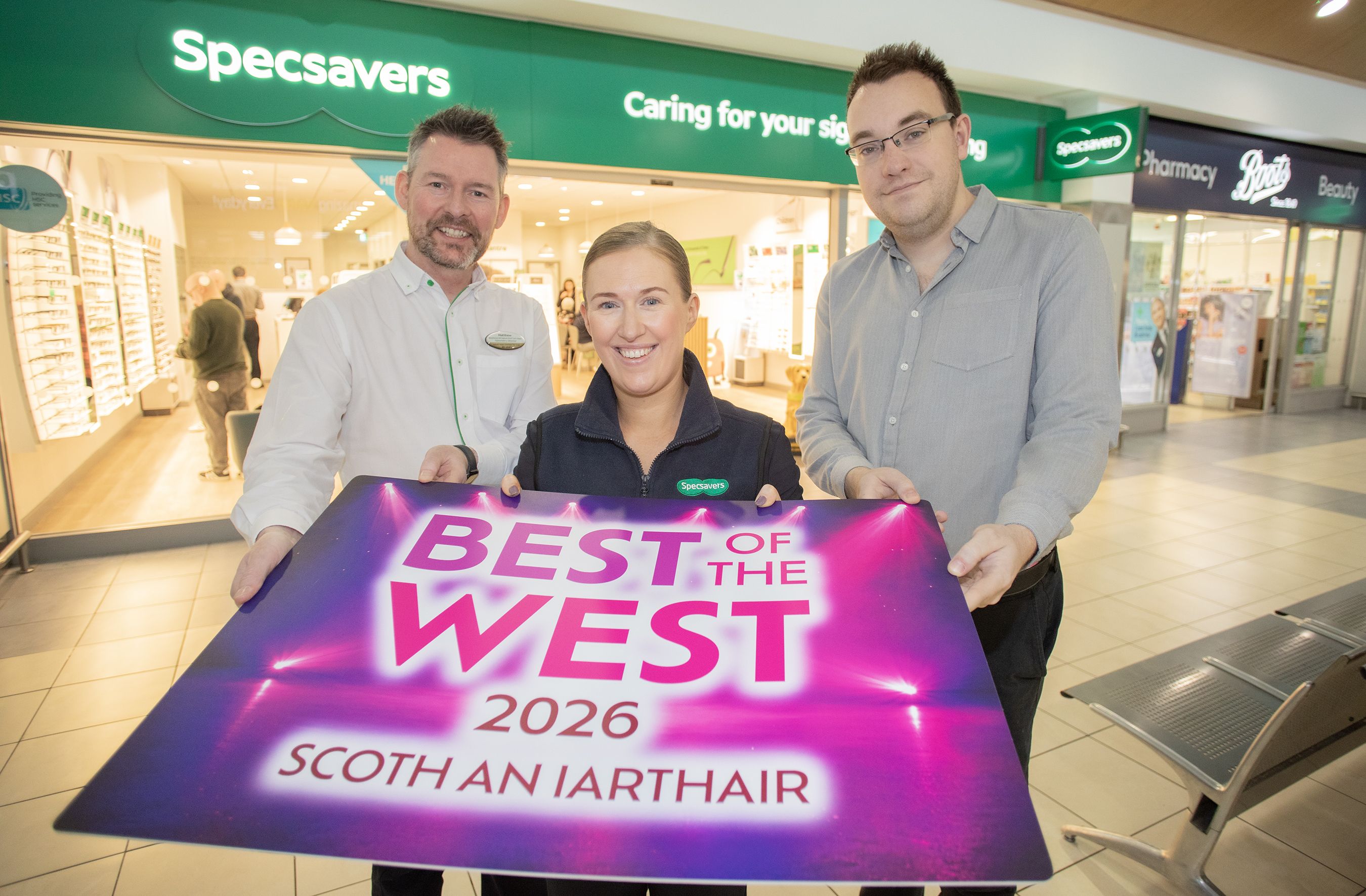 BEST OF THE WEST: Matthew McKenny and Louise Shortt from Specsavers Park Centre with Conor McParland from Andersonstown News
