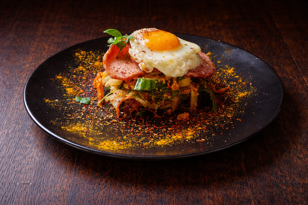 PLATING UP: Curried couscous with bacon medallions and fried egg 