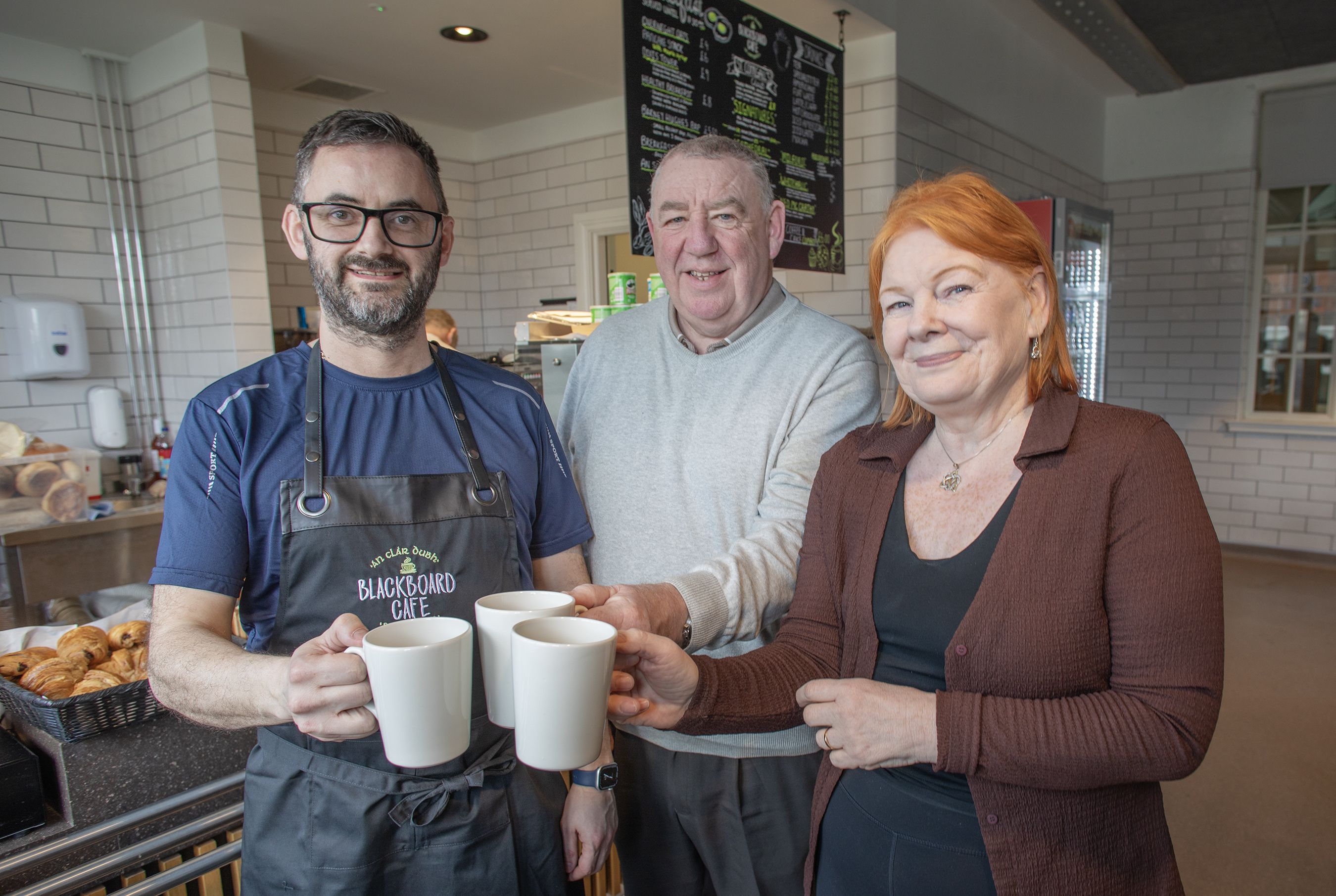 NEW VENTURE: Kevin McElkerney, owner of An Clár Dubh/Blackboard Café, with Gerry McConville and Marie Maguire from St Comgall\'s