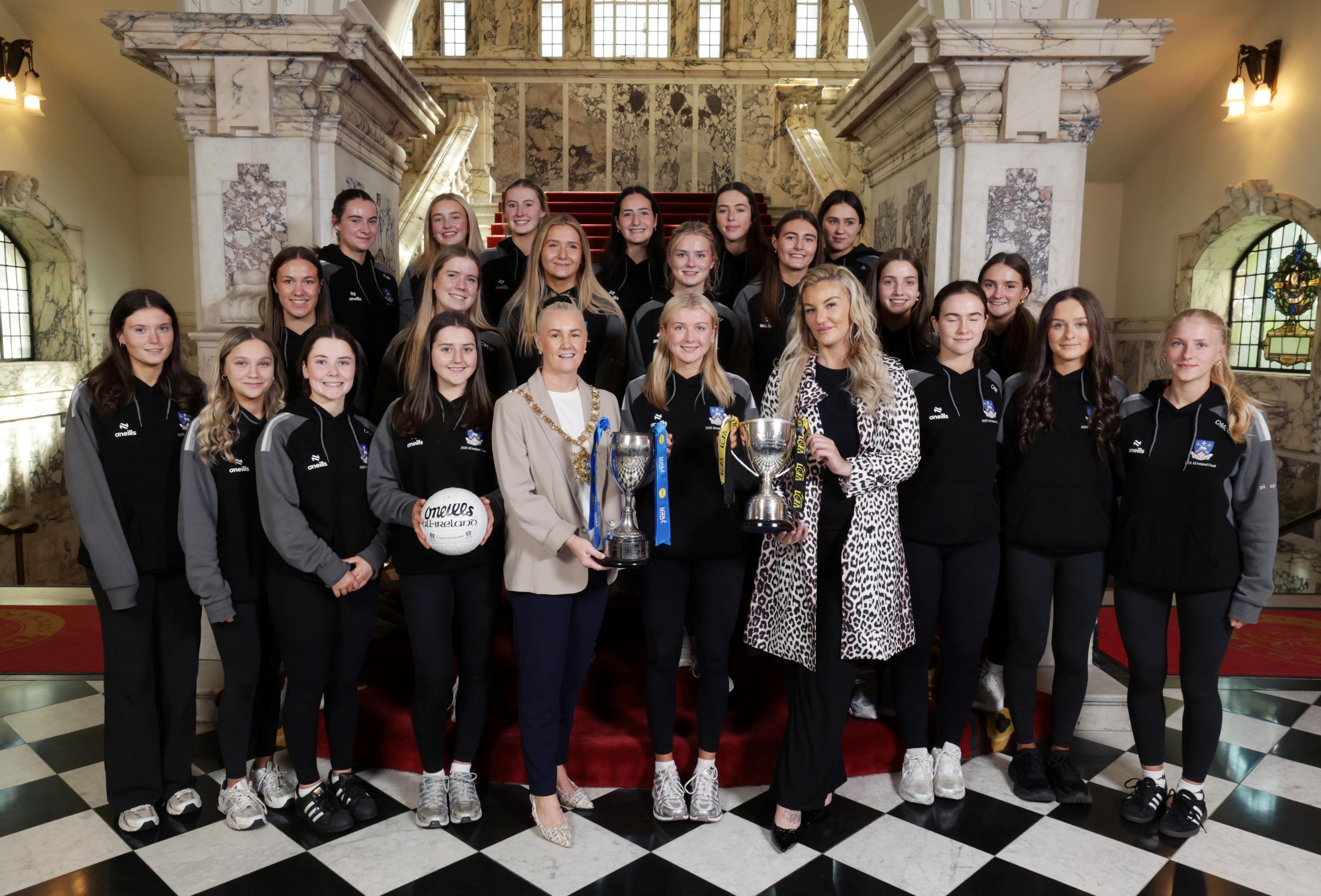 SPORT STARS: Lord Mayor of Belfast, Councillor Tracy Kelly, Our Lady and St Patrick’s College, Knock captain Isa McCarron and MMA champion Leah McCourt, with the winning team