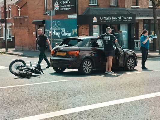 Teenager hospitalised after car and scrambler collision on Falls Road