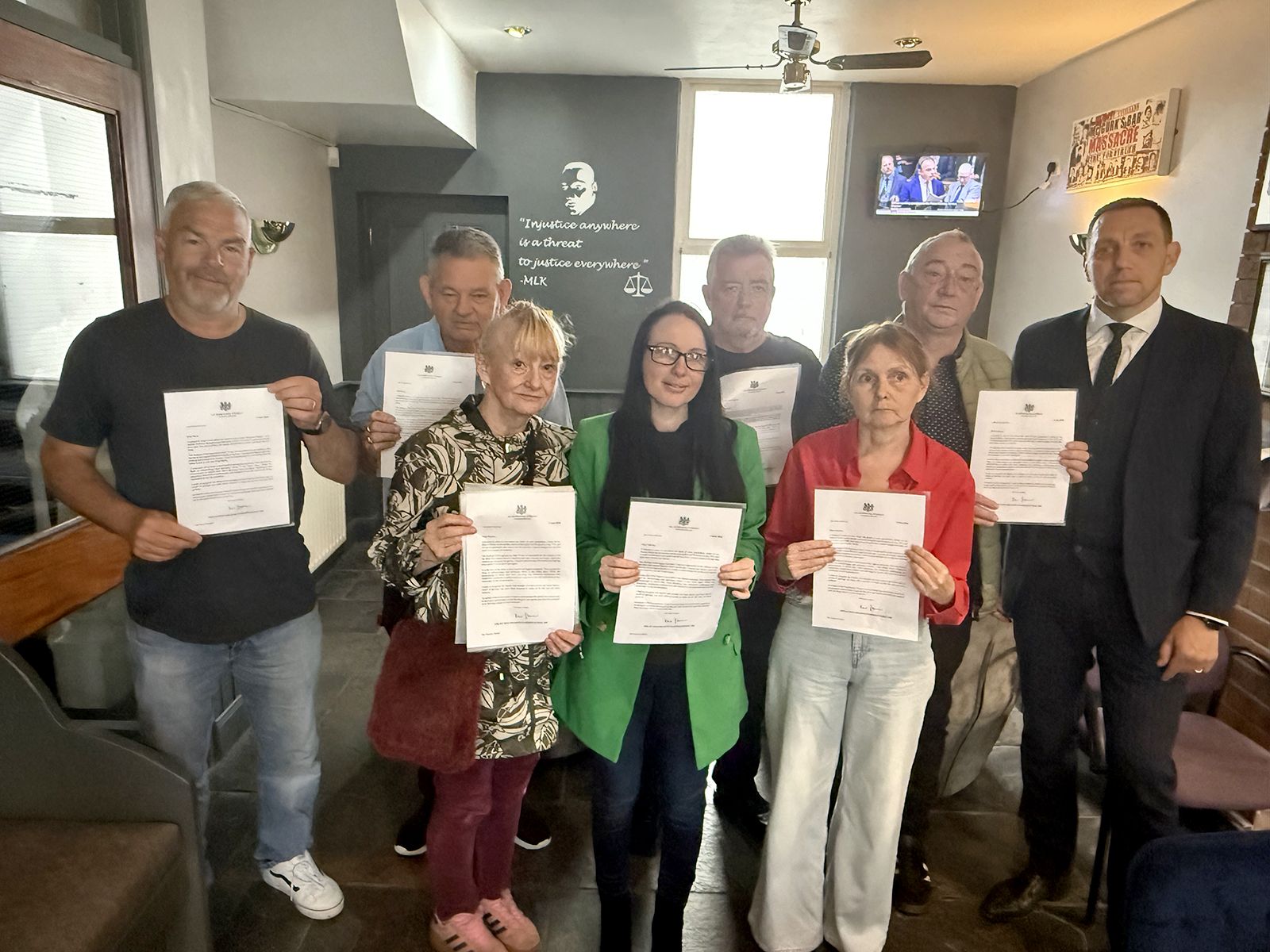 WELCOME: The Springhill families with their letters of apology with solicitor Pádraig Ó Muirigh