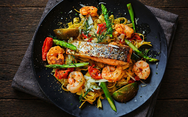 PLATING UP: Pan fried salmon fillet with asparagus and prawns