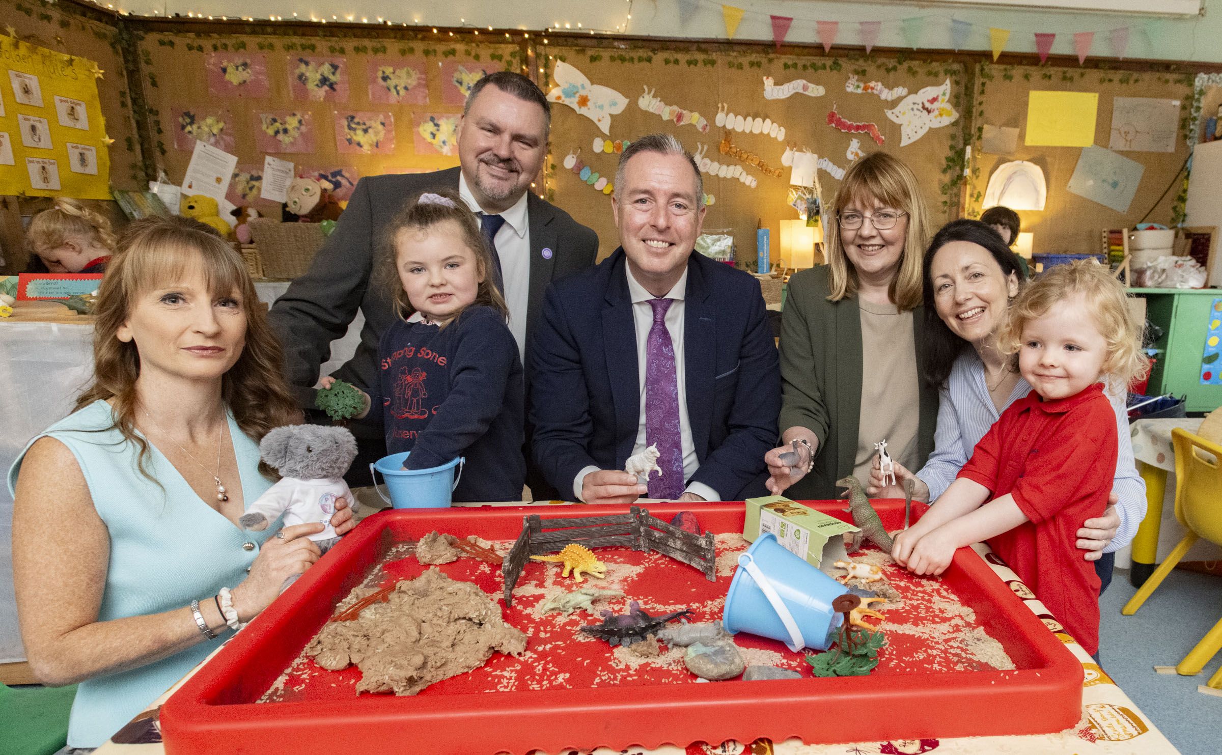 Susan Williams (SEN Inclusive Play Project), Alan Herron (Playboard NI CEO), Education Minister Paul Givan, Elaine Loughran (Principal Our Lady of Lourdes Primary School) and Edwina Weiniger (Stepping Stones Chairperson) with pupils