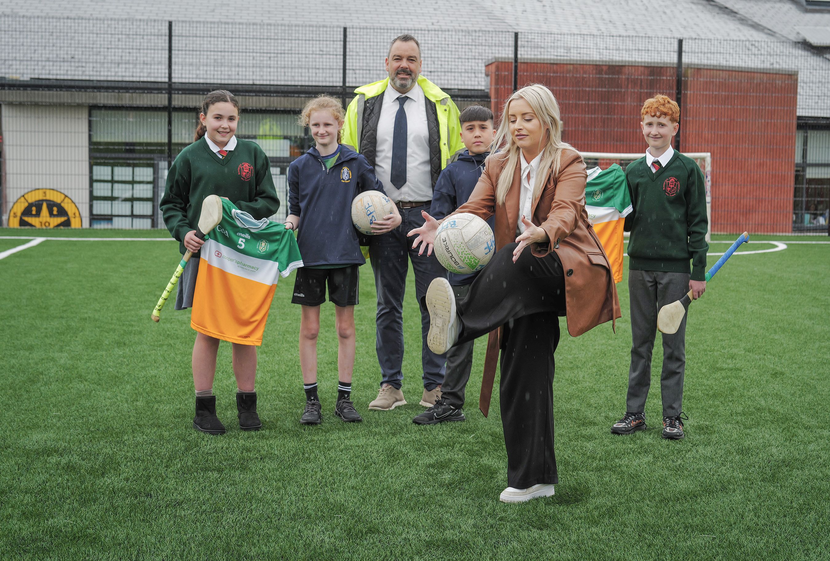 ON THE BALL: Bunscoil Phobail Feirste Principal Séamus Ó Tuama, West Belfast MLA Órlaithí Flynn with pupils Lochlann, Mary Kate, Clodagh and Ciarán