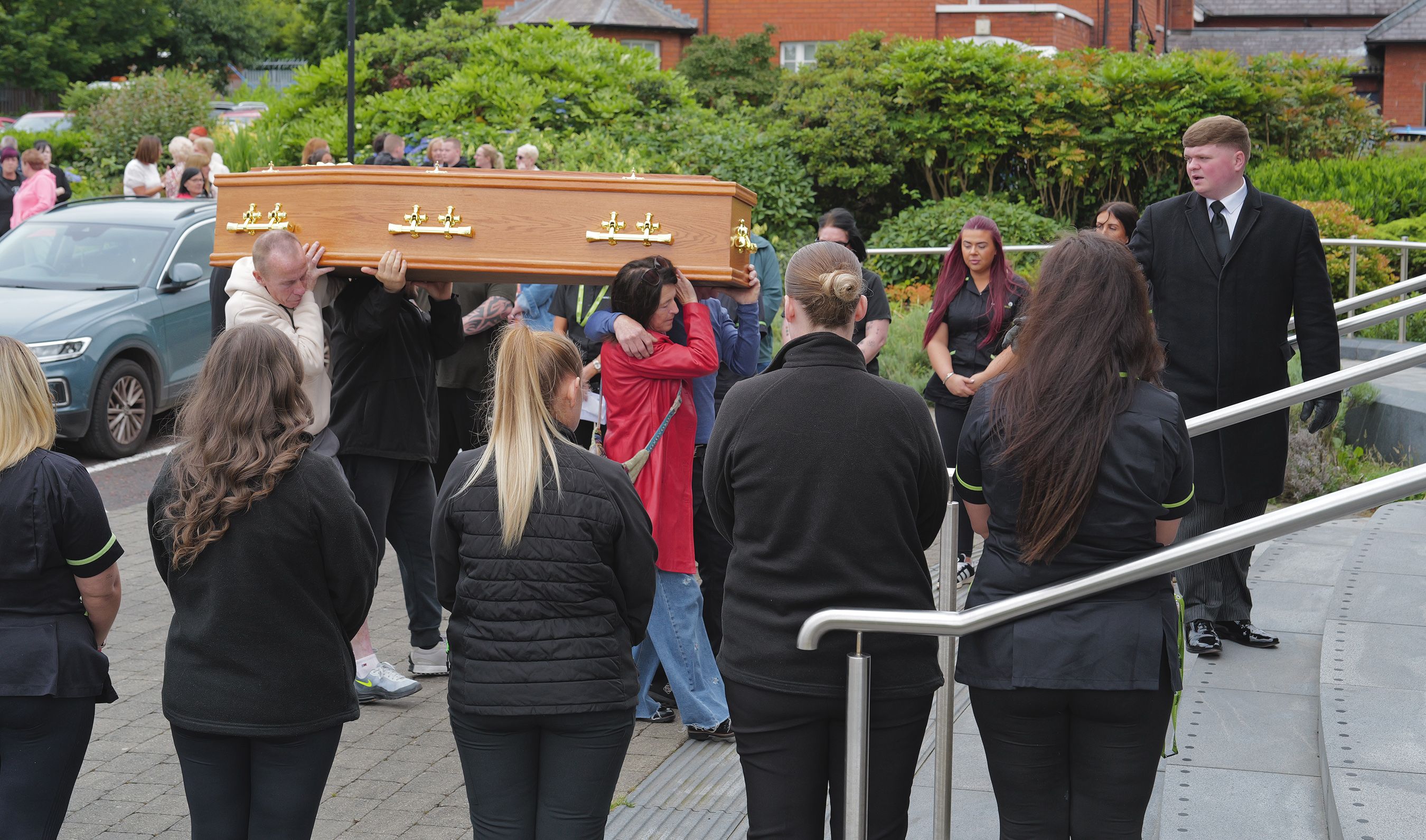 RESPECT: Care workers from Connected Health form a guard of honour at the funeral of Patrick McNally on Wednesday morning