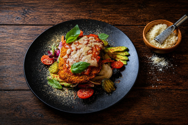 PLATING UP: Chicken parmigiana with Avocado, cherry tomatoes