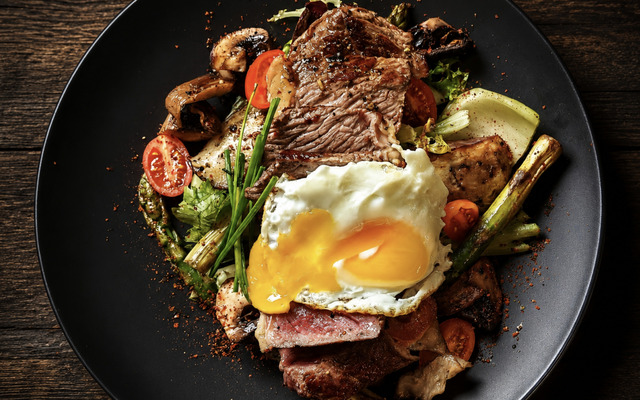 PLATING UP: Grilled sirloin steak, roast vegetables with runny egg